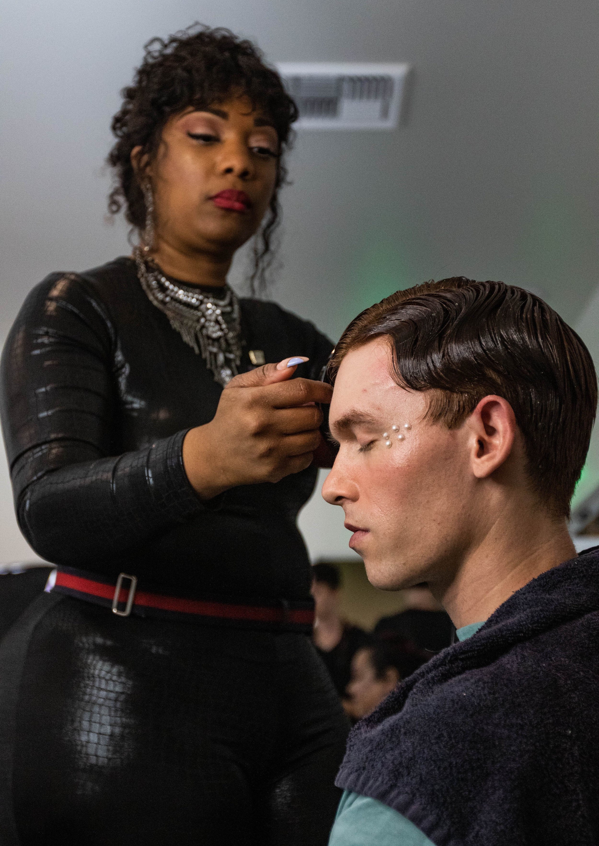  Hairstylist Melissa Robinson gives model Jack Sajwaj a soft wave for his look for designer Francis Libiran before he walks for Los Angeles Fashion Week. Oct. 7, 2022. Los Angeles, CA. (Ee Lin Tsen | The Corsair) 