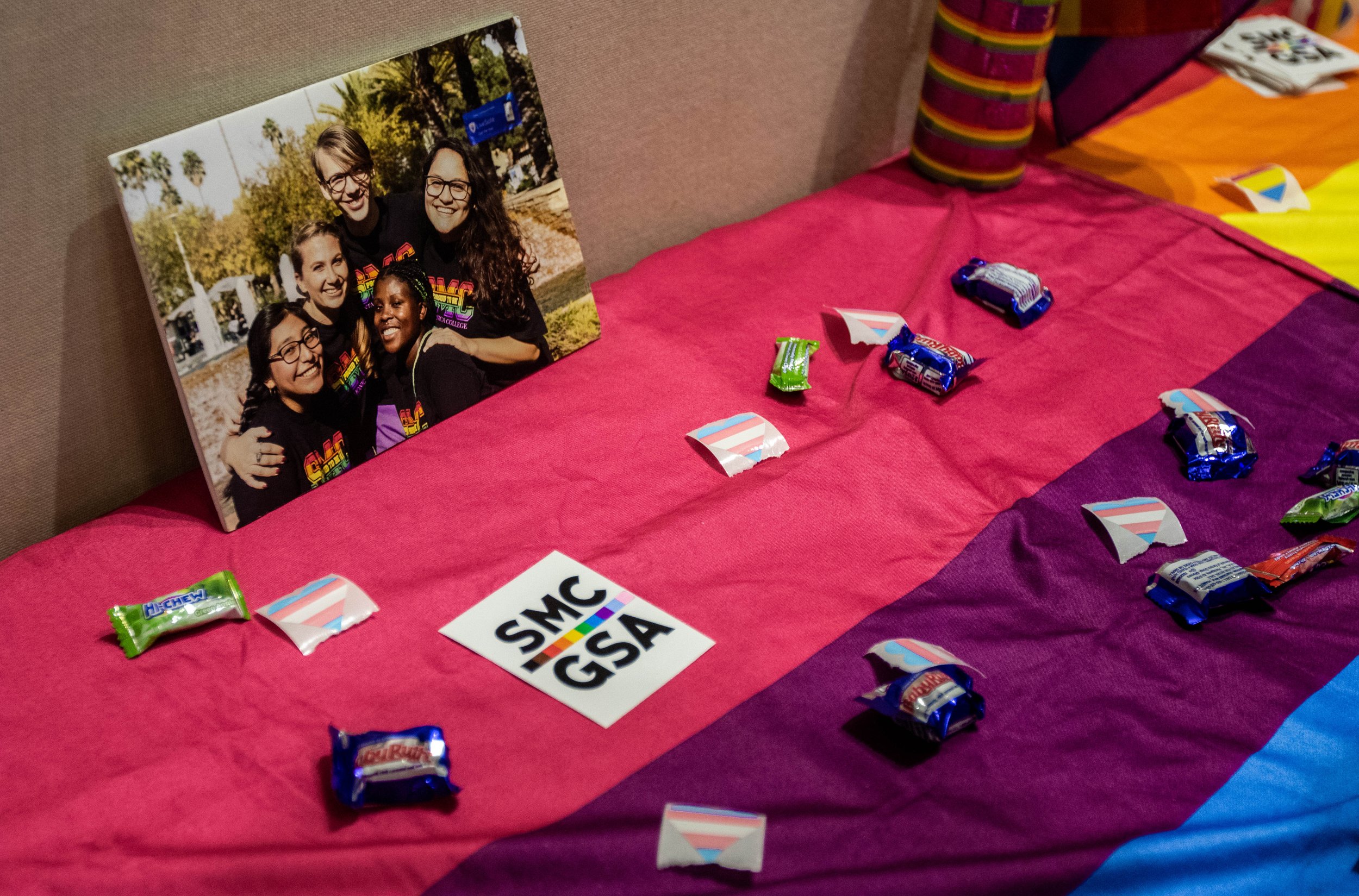  A booth set up by the Santa Monica College Gender Sexuality Club by the stage of the Student Services Orientation Hall. The booth is filled with GSA pins and candy to promote the GSA Club to students attending SMC guest speaker Denice Frohman's poet