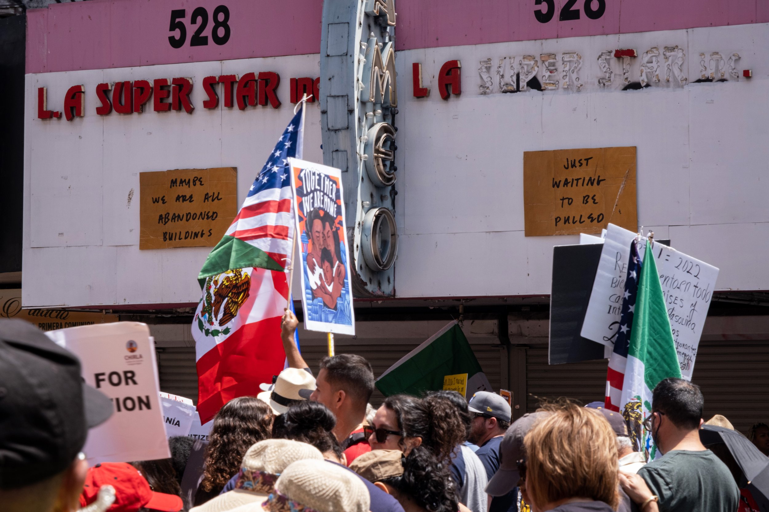  The crowd of hundreds continues marching down Broadway street, passing abandoned buildings, in Los Angeles, on Sunday, May 1, 2022. (Anna Sophia Moltke | The Corsair) 