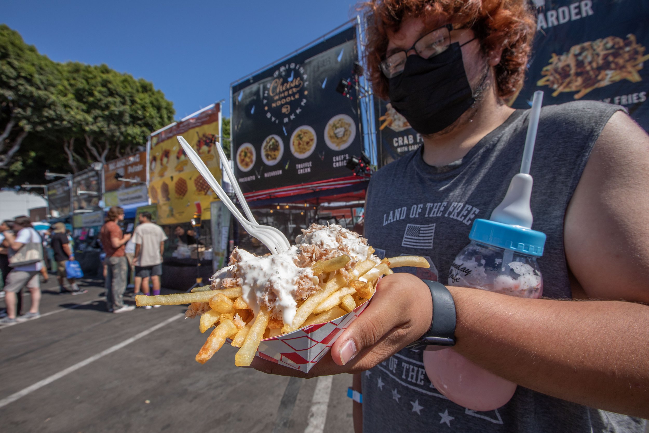  Freddy, one of the many goers at the event, holds a just made Crab Fries from one of the vendors. Inspired by famous nighttime bazaars of Asia, 626 Night Market Mini was established in 2012, this large-scale market is named after the 626 area code r