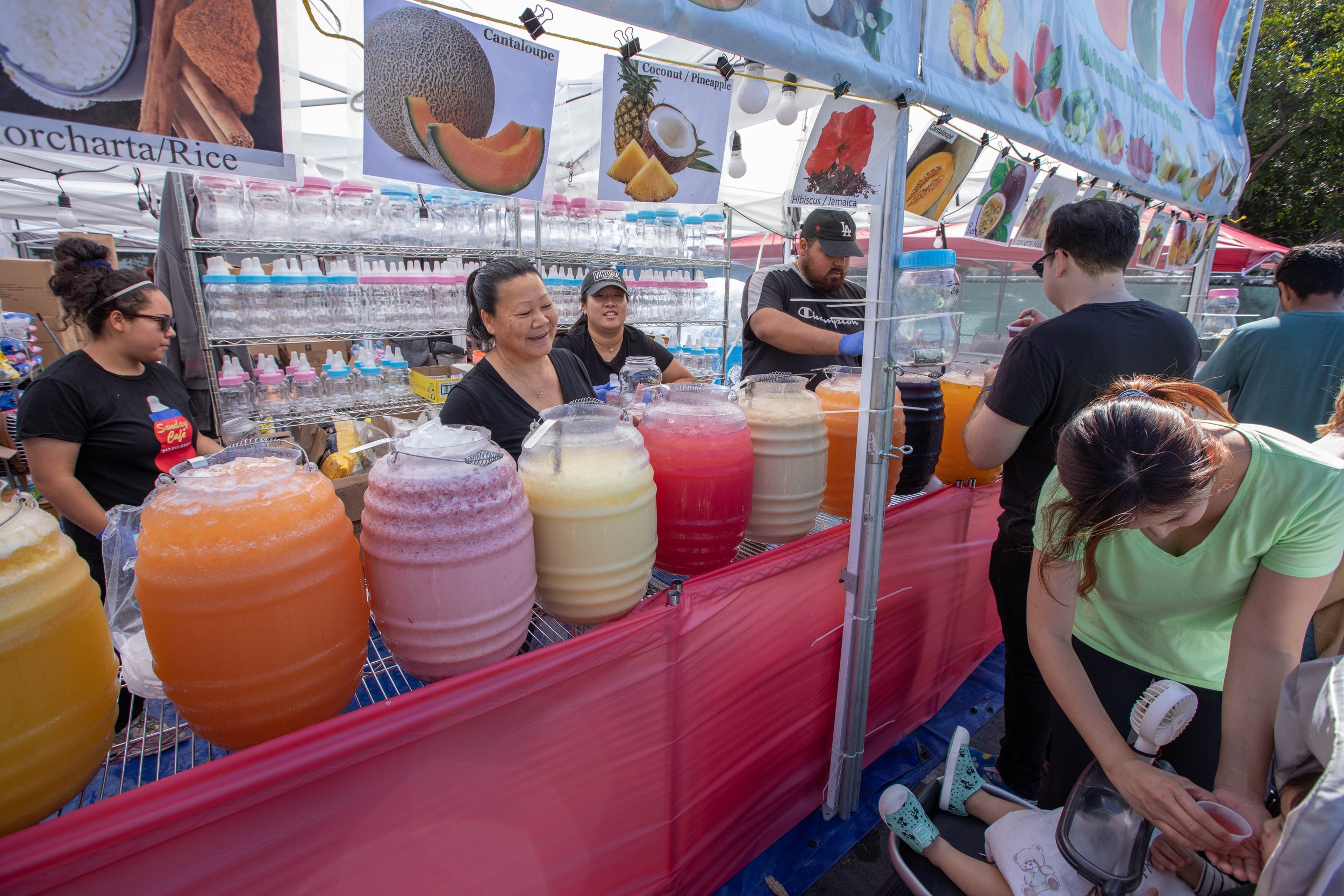  Diana Espinoza behind the counter enjoys the looks of the baby in front tasting a fresh watermelon juice sample. Inspired by famous nighttime bazaars of Asia, 626 Night Market Mini was established in 2012, this large-scale market is named after the 