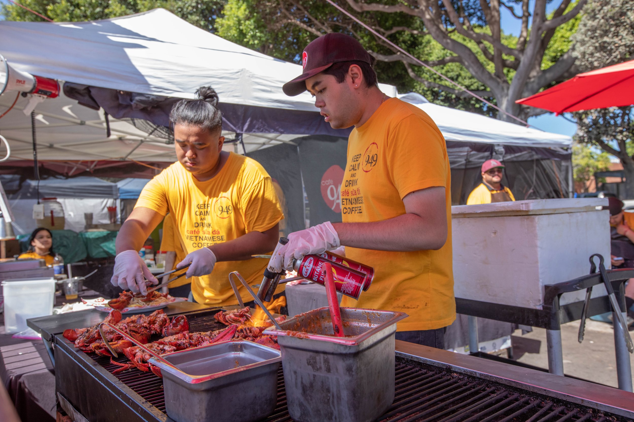  The crew of the Vietnamese vendor Cafe 949 prepares a grilled lobster dish. Inspired by famous nighttime bazaars of Asia, 626 Night Market Mini was established in 2012, this large-scale market is named after the 626 area code region of San Gabriel V