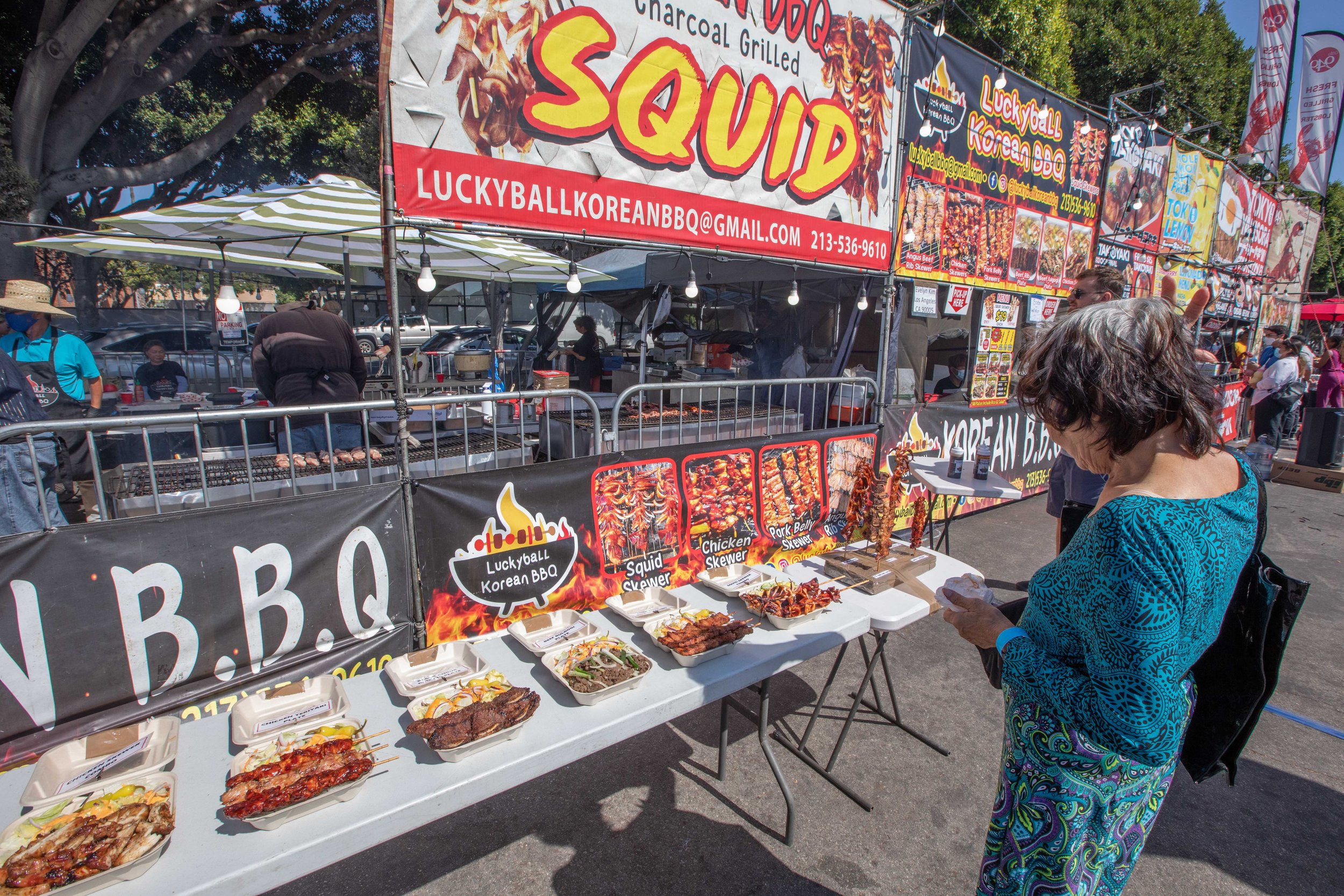  An attendant takes her time in front of a very colorful display of Korean squid barbecue dishes. Inspired by famous nighttime bazaars of Asia, 626 Night Market Mini was established in 2012, this large-scale market is named after the 626 area code re