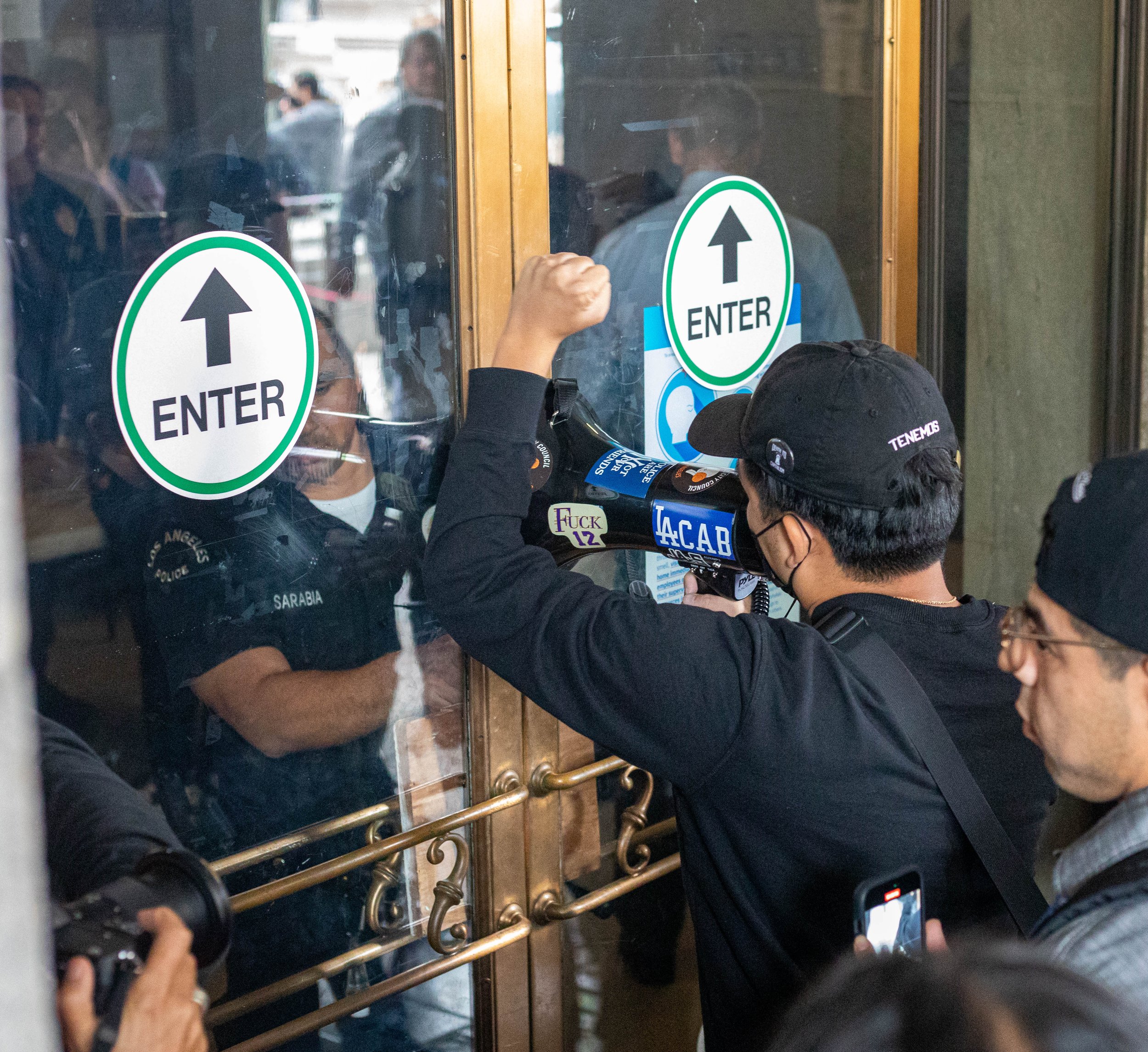  Protester demanding to be let in for the public council meeting towards LAPD inside the city hall who is barracading the door from anyone entering on Tuesday, Oct. 11, 2022 at Los Angeles, Calif. (Danilo Perez | The Corsair) 