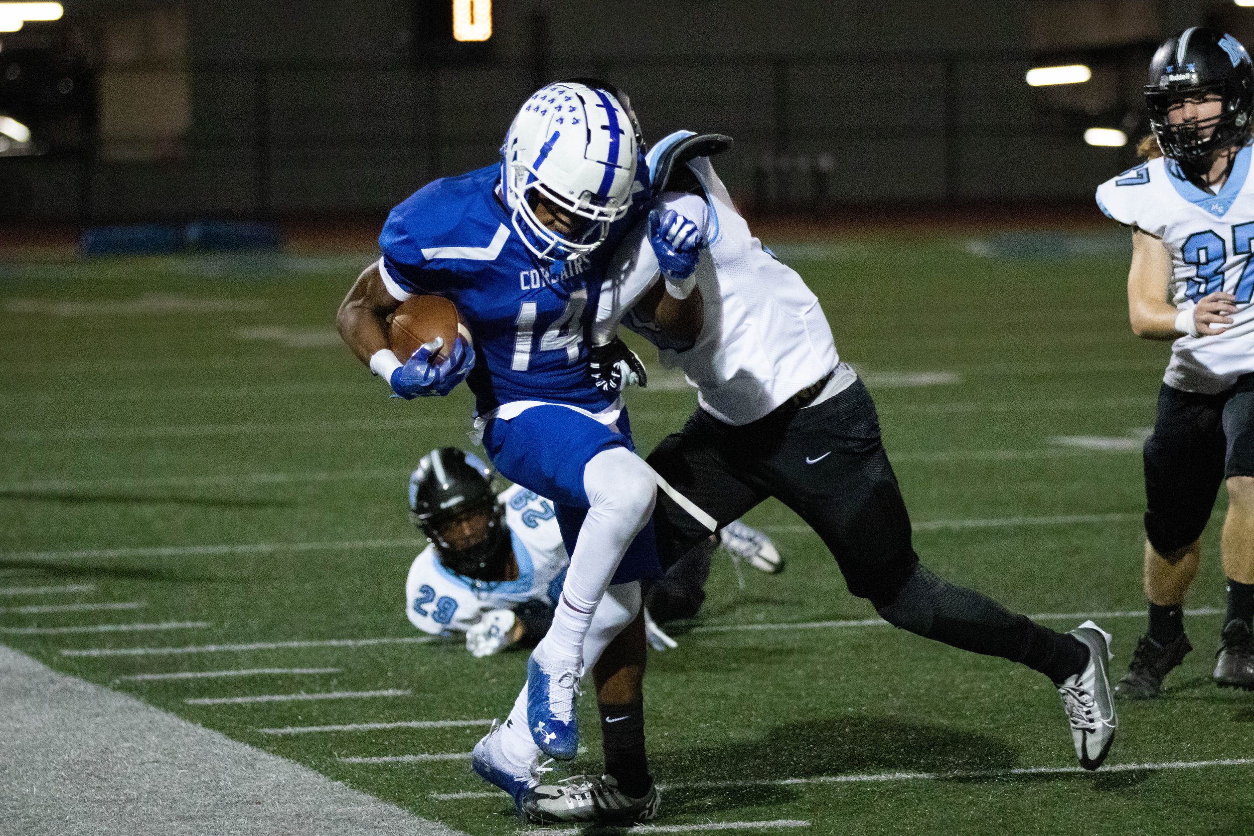  Santa Monica College Corsair wide receiver Jaboree Thornton (14, left) being tackled by Moorpark College Raider wide receiver Khalil Collins (89, middle left) during the fourth quarter of a recent home game on Thursday, Oct. 13, 2022, at Santa Monic