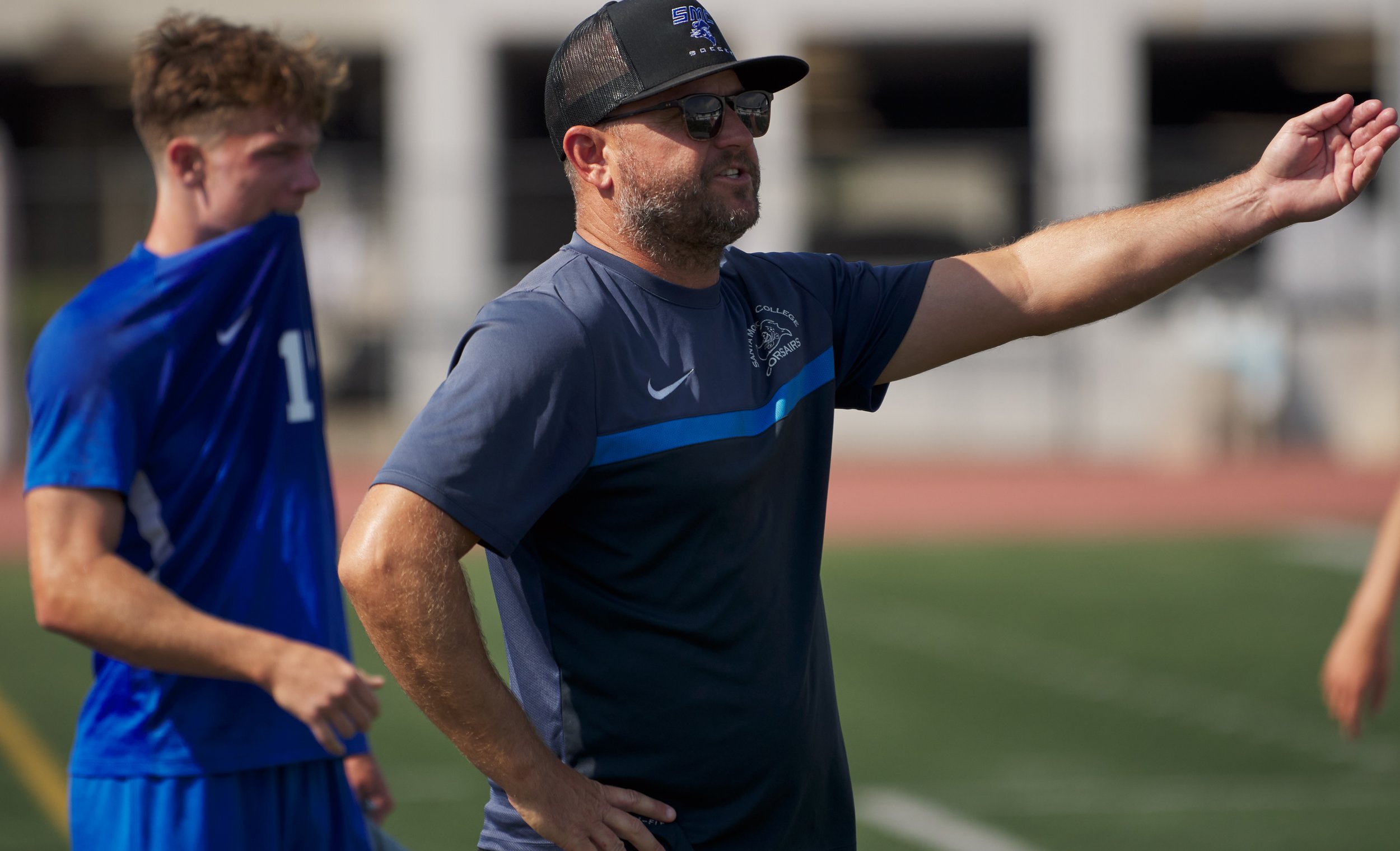  Santa Monica College Corsairs Men's Soccer Head Coach Tim Pierce (right) calls to pull Roey Kivity from the field after getting a yellow card, while Taj Winnard (left) chews his shirt, during the match against the Santa Barbara City College Vaqueros