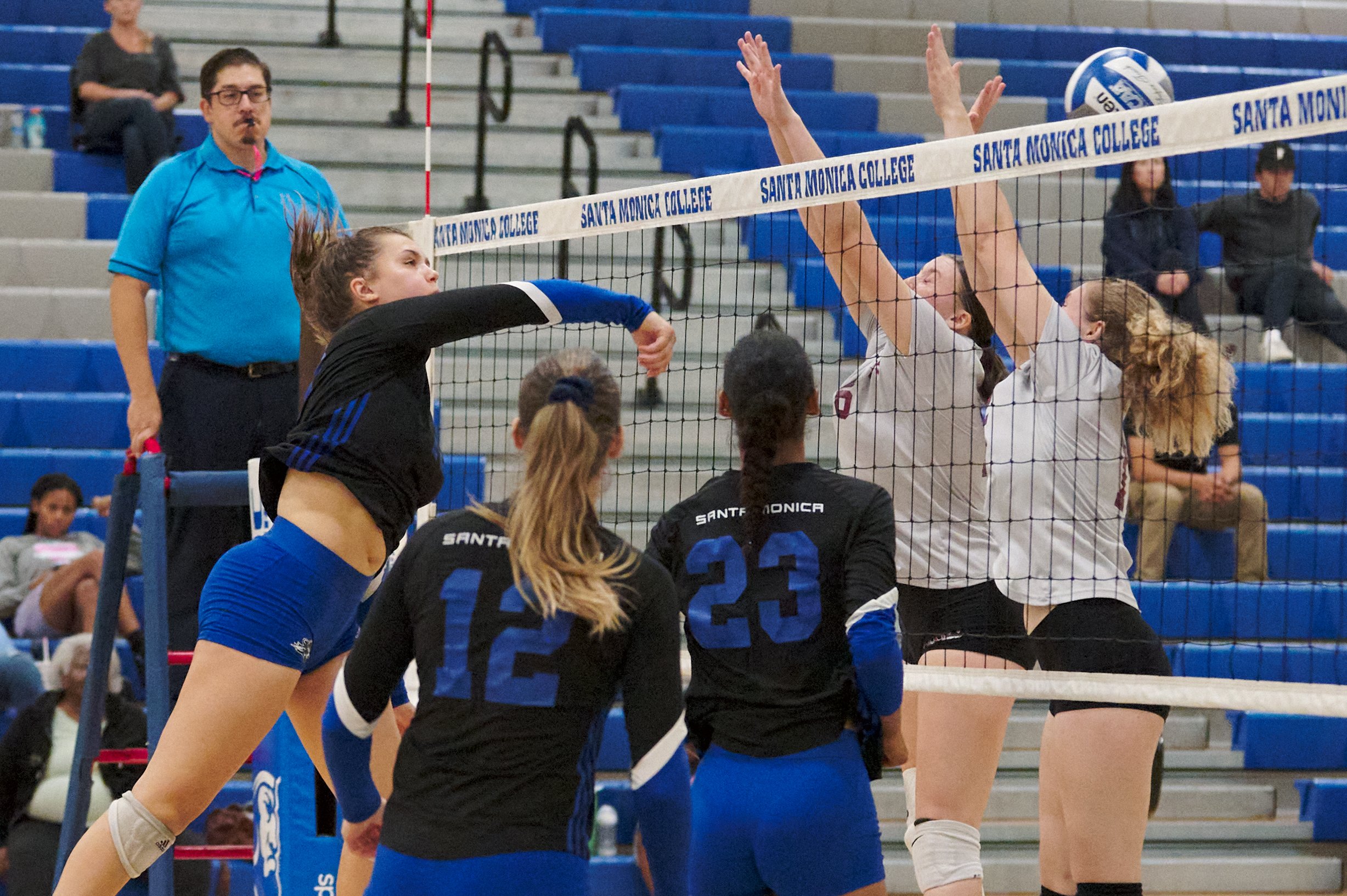  Santa Monica College Corsairs' Mackenzie Wolff hits the ball past the defense of Antelope Valley College Marauders' Ella Gawallek and Sabre Jensen during the women's volleyball match on Wednesday, Oct. 12, 2022, at the Corsair Gym in Santa Monica, C