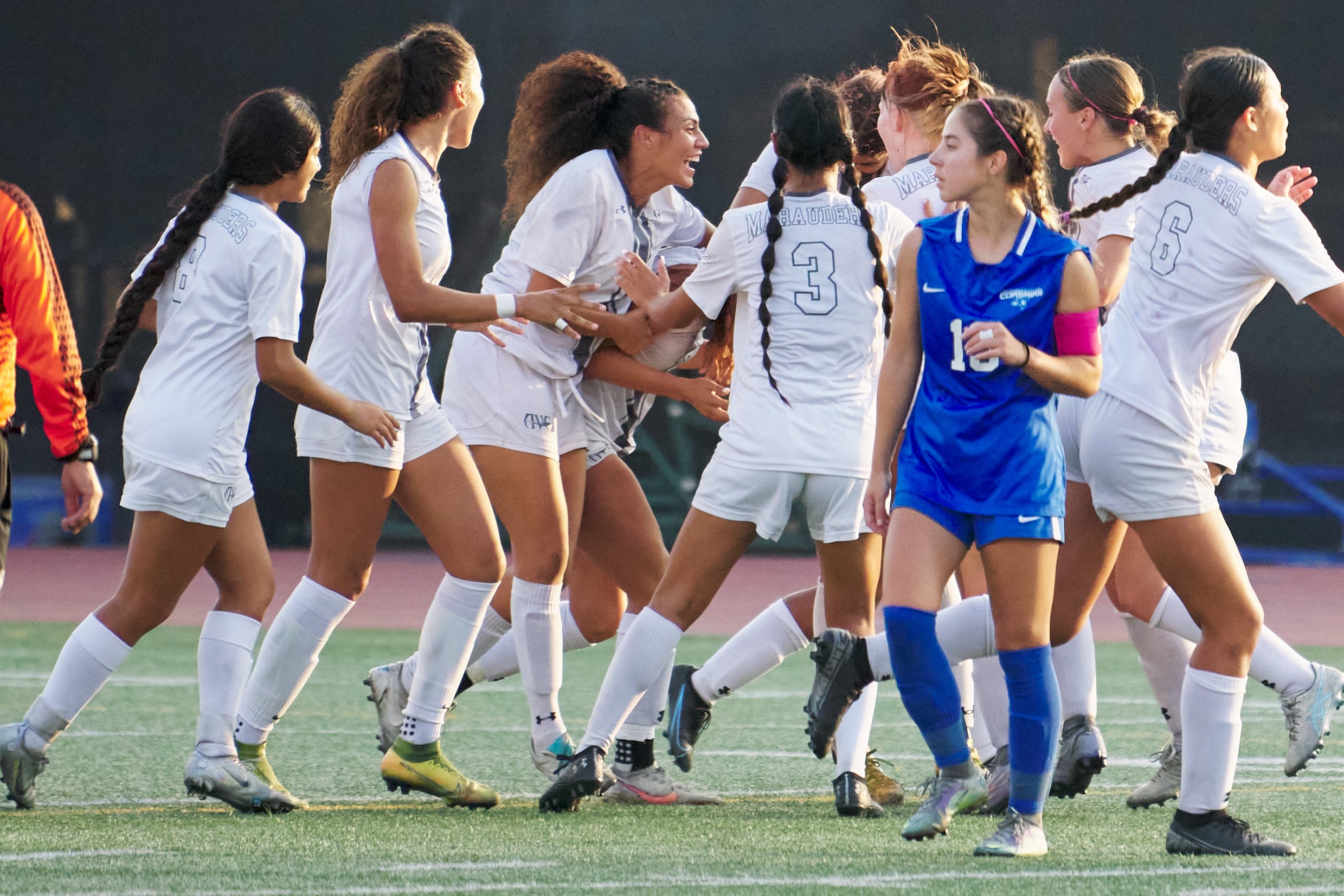  Members of the Antelope Valley College Marauders pass Santa Monica College Corsairs' Sophie Doumitt (in blue) as they celebrate their second goal of the women's soccer match on Tuesday, Oct. 11, 2022, at Corsair Field in Santa Monica, Calif. The Cor