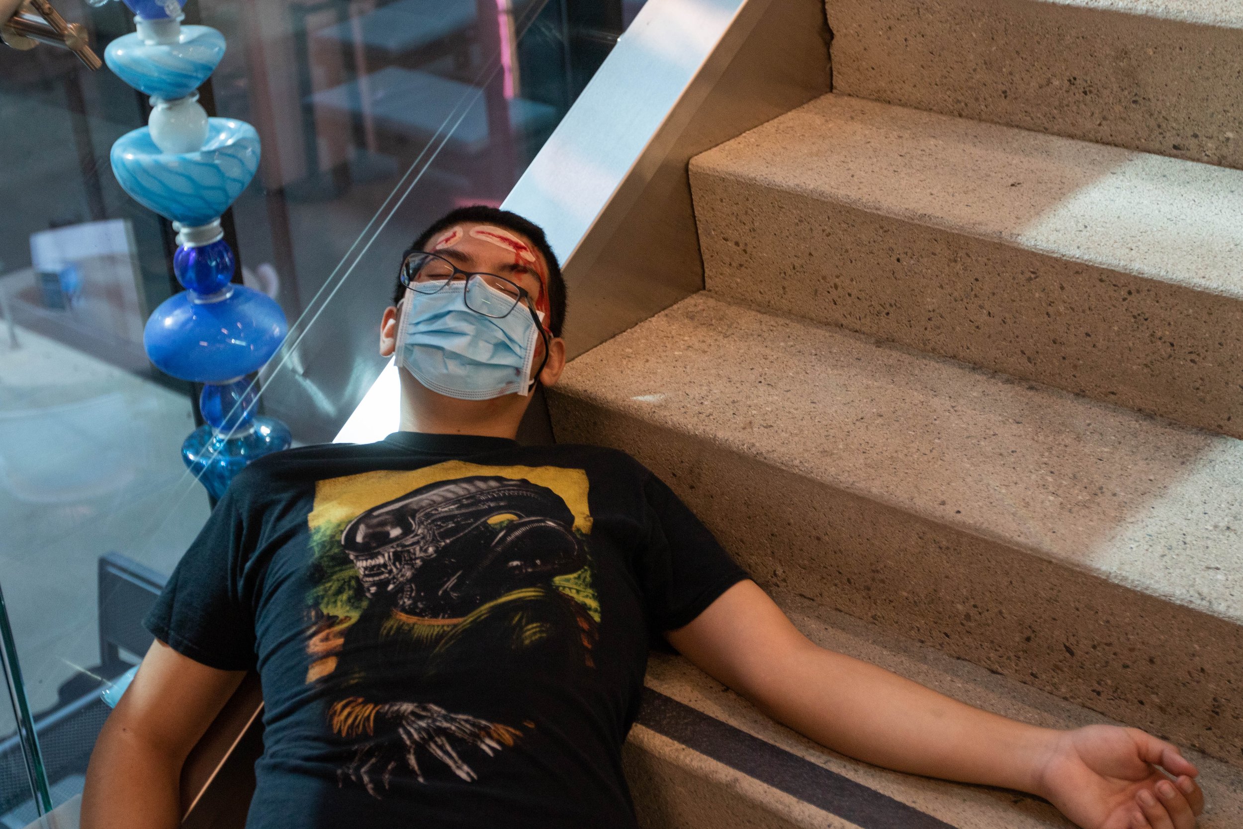  Santa Monica College (SMC) student Daniel Torres lies on the staircase of the SMC Student Services Center as he participates as a simulated injured drill participant with a head injury for the 2022 Great ShakeOut SoCal Earthquake Drill and Media Eve