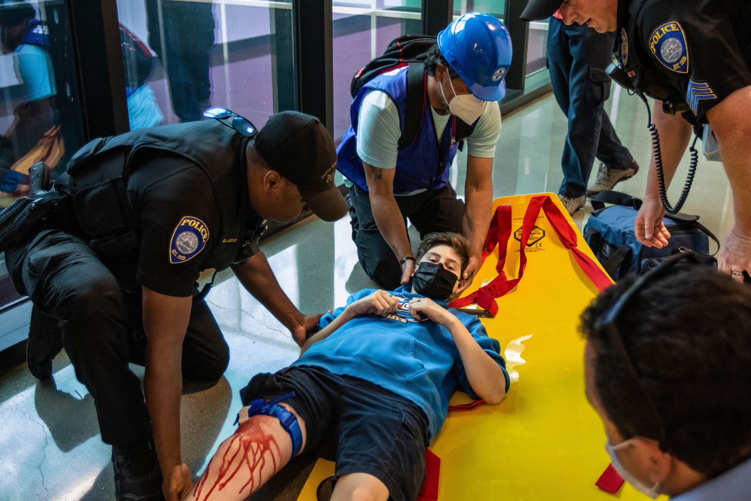  Alex Bonin, one of the simulated injury drill participants of the 2022 ShakeOut SoCal Earthquake Drill and Media Event receives emergency assistance from the Santa Monica College (SMC) Police Department and Campus Emergency Response team. The team m