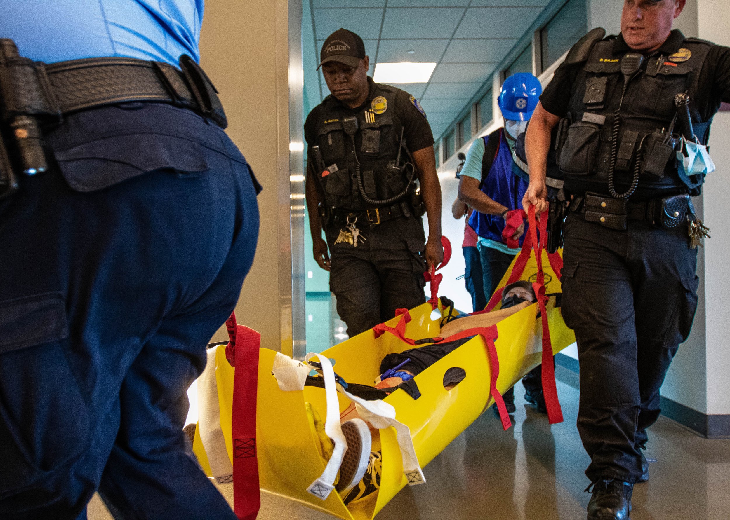  (L-R) Armando Barocio, Dominic Jester, Jorge Valadez, from the Campus Emergency Response Team and Sargent Bryan Wilson from the Santa Monica College (SMC) Police Department rescues Alex Bonin, one of the simulated injury drill participants of the 20