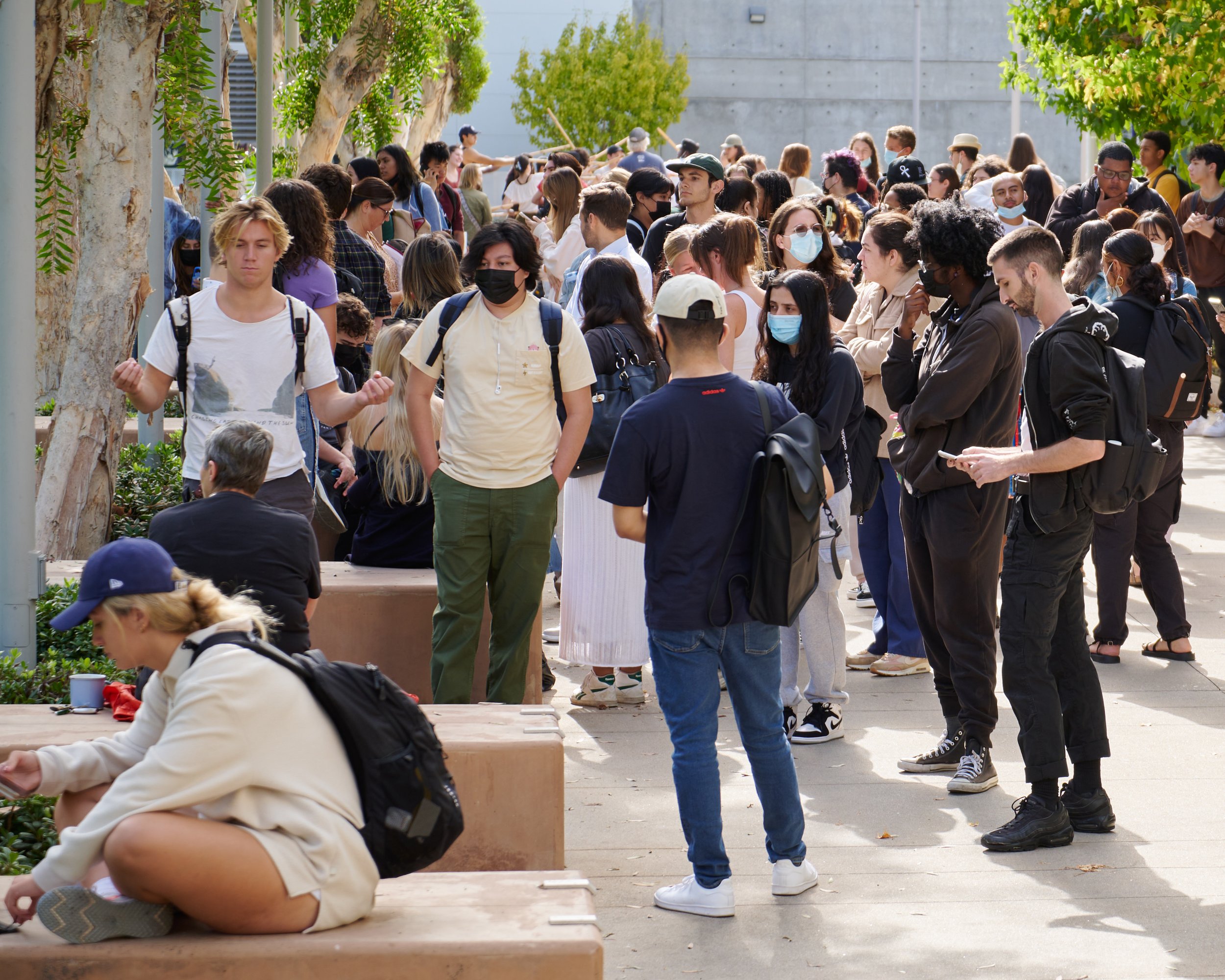  Students gather at SMC quad at Santa Monica College after being evacuated as part of The Great California ShakeOut, while, in the distance, the Theatre Arts Beginning Stage Combat class continues unabated on Thursday, Oct. 20, 2022, in Santa Monica,