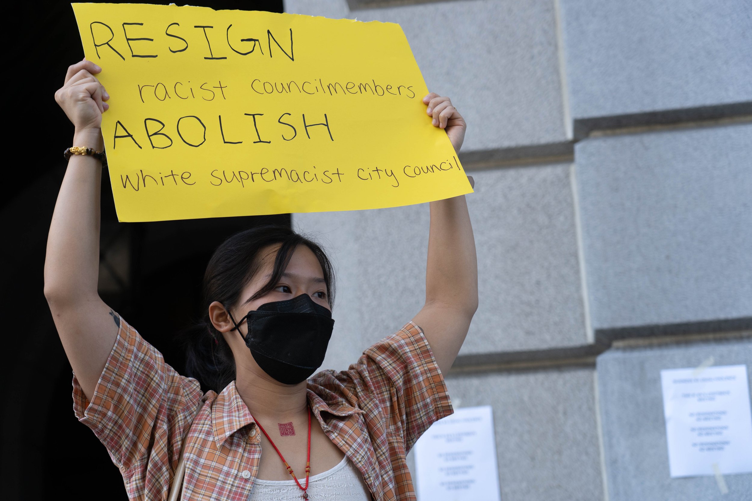  A demonstrator brandishes a homemade protest sign at the entrance of Los Angeles City Hall during a demonstrator against the City Council Tuesday, Oct 18 2022. Multiple activist organizations are demanding the resignation of hispanic council members