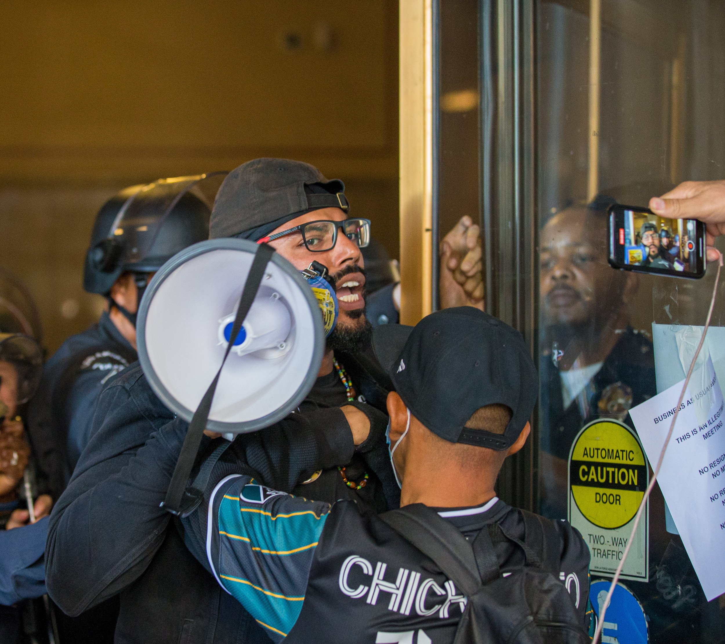  Joseph Williams(L) being pushed outside of the Los Angeles City Hall by LAPD wearing riot gear after Williams and others made their way inside the city hall calling for the resignation of Kevin De Leon on Tuesday, Oct. 18 at Los Angeles, Calif. Afte
