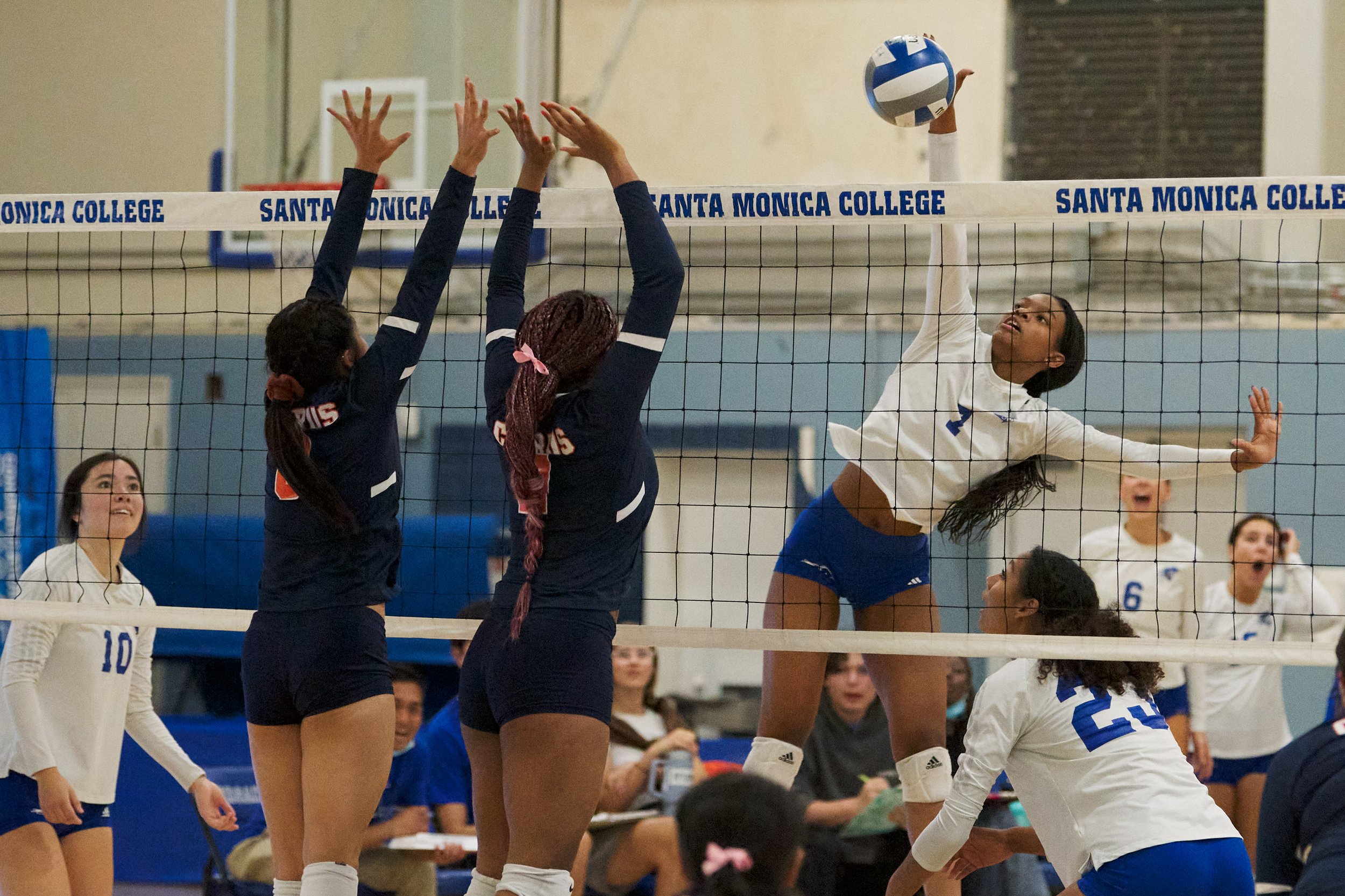  Santa Monica College Corsairs' Zarha Stanton (right) hits the ball past Citrus College Owls' Sabrina Evangelista and Kalin Greene during the women's volleyball match  on Wednesday, Oct. 19, 2022, at Corsair Gym in Santa Monica, Calif. The Corsairs w