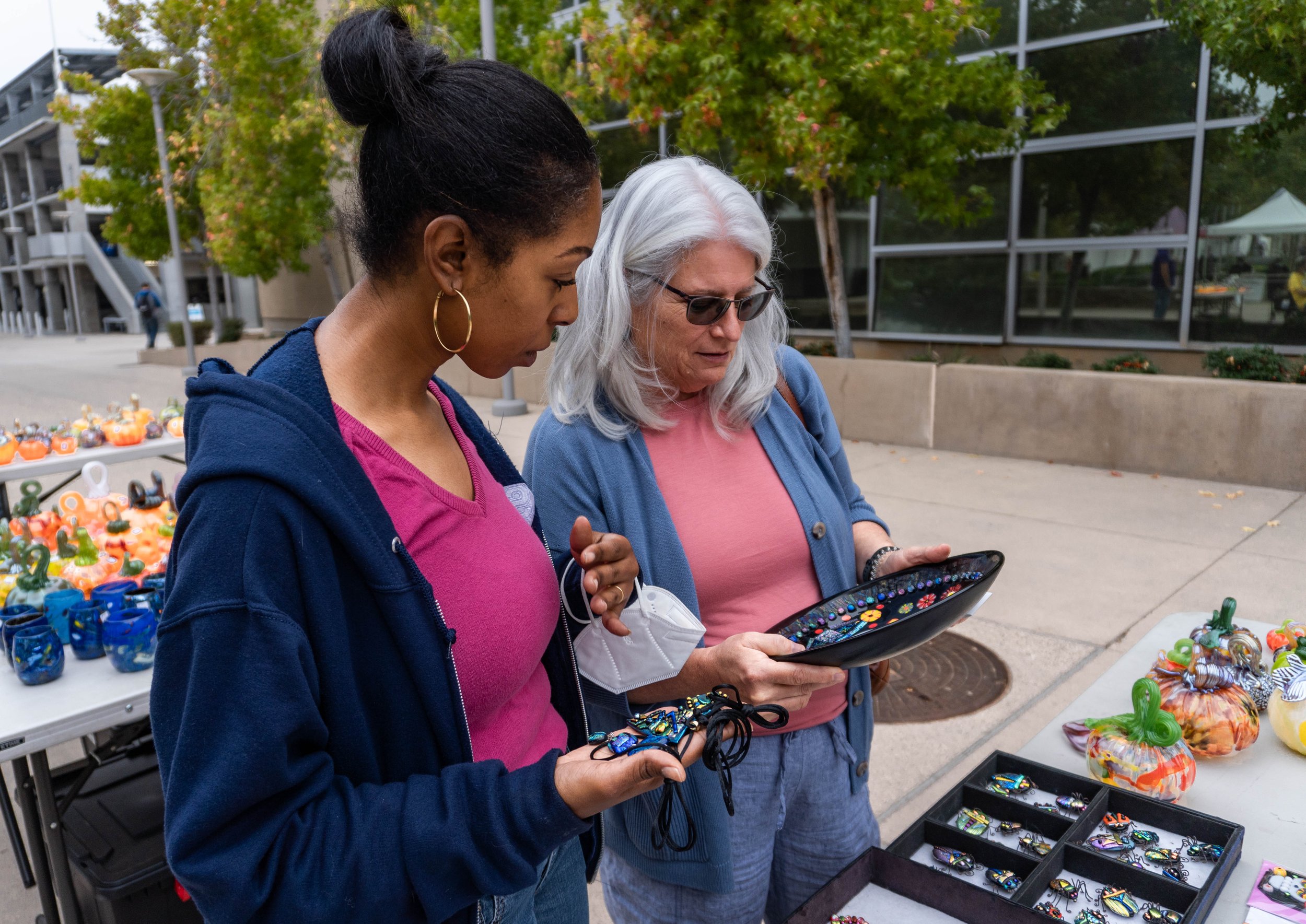  Anisha DiGregorio, Santa Monica College (SMC) Human Resource staff and Susan Caggiano, a faculty member of the English department browse through the many art pieces for sale at the SMC Art Department's annual Glass Pumpkin Sales. DiGregorio has been