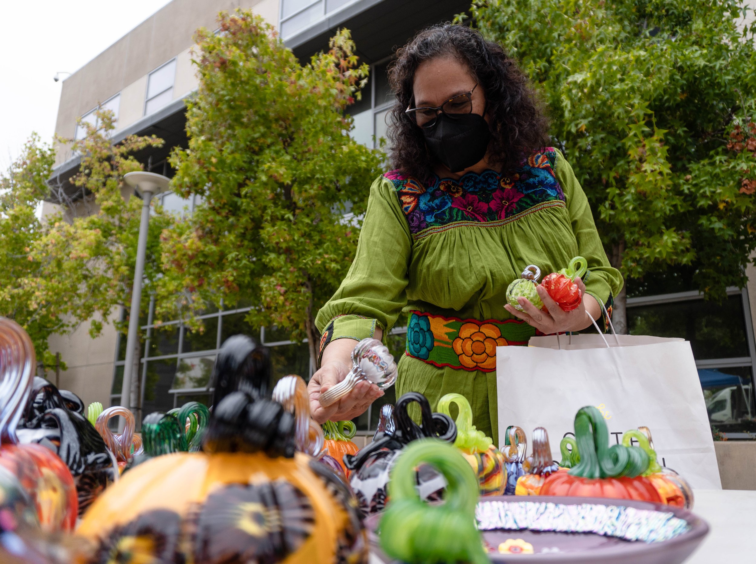  Maria Martinez, a counsellor at Santa Monica College looks for  6 glass pumpkins to gift each of her son's school teachers at the SMC Art Department's annual Glass Pumpkin Sales. Martinez has been giving out the Art Department's pumpkins as gifts to