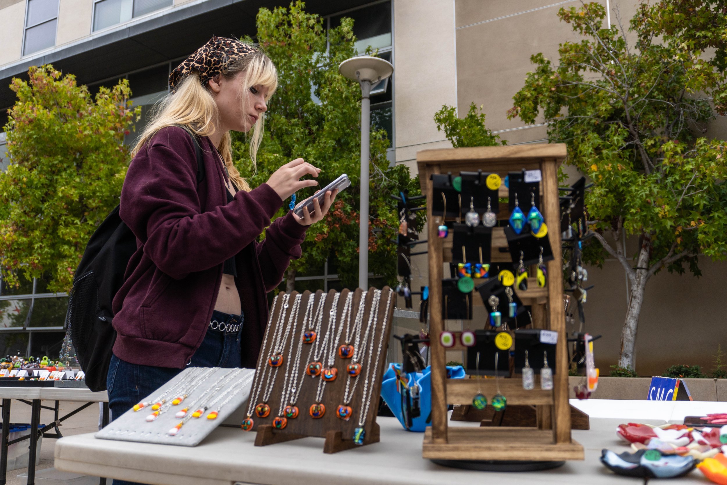  Santa Monica College student Clover Levinson purchases a pair of blue glass earrings for her grandmother's Christmas present at the SMC Art Department's annual Glass Pumpkin Sales. The sale took place in front of the Quad by the Core Performance Cen