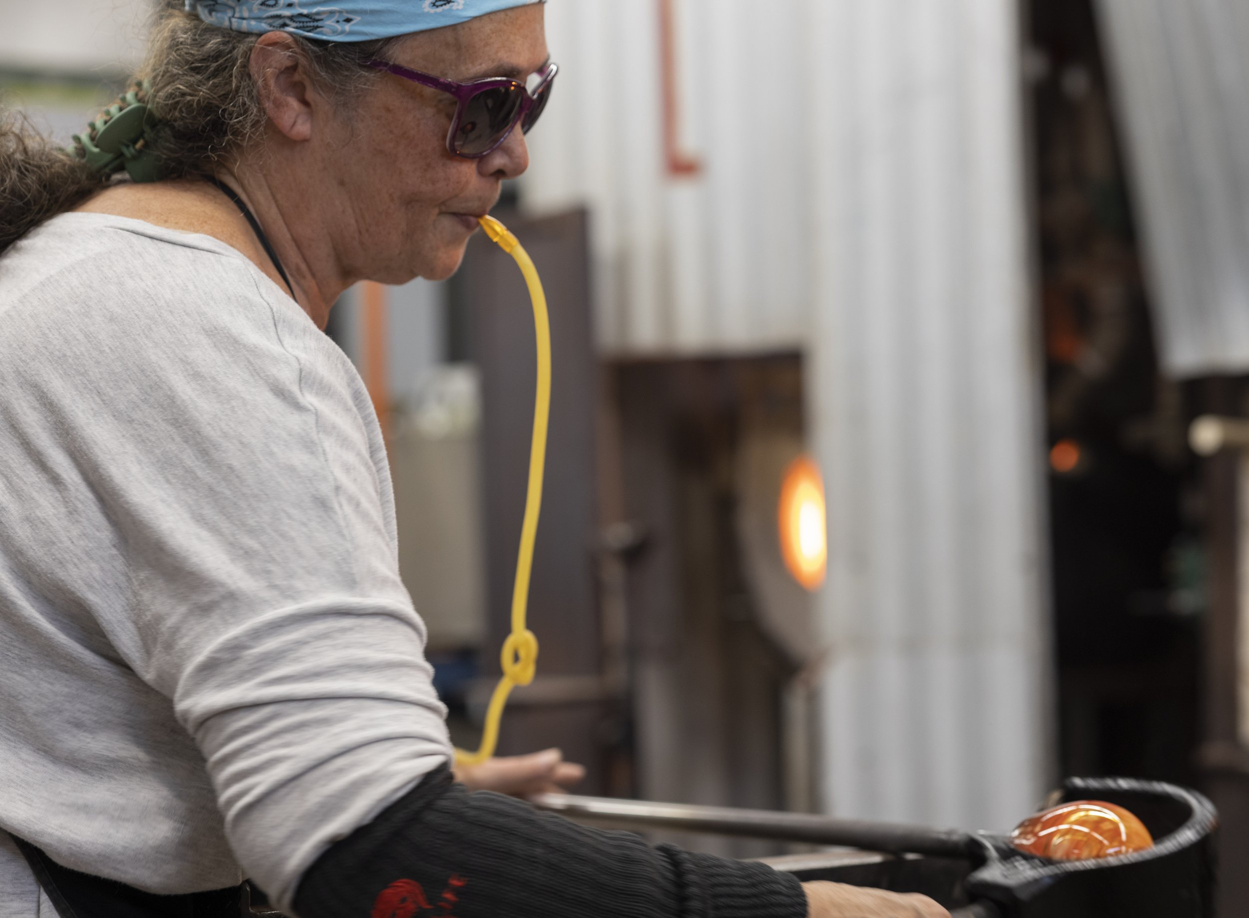  Alexis Dannings, a student at Santa Monica College, rolling molten glass in order to get it ready to be blown into a bowl. October 13, 2022, Santa Monica, Calif. (Jamie Addison | The Corsair) 