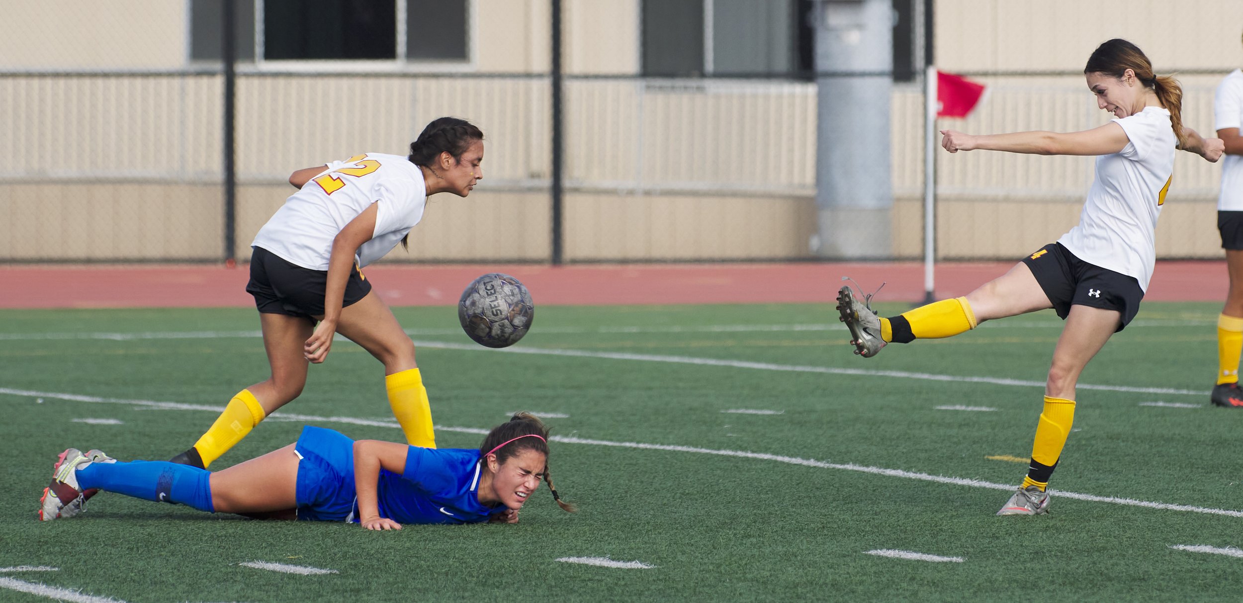  Santa Monica College Corsairs' Ali Alban falls to the ground from a foul by Glendale Community College Vaqueros' Santi Eldimiri, while fellow Vaquero Luisa Salsedo kicks the ball during the women's soccer match on Friday, Oct. 21, 2022, at Corsair F