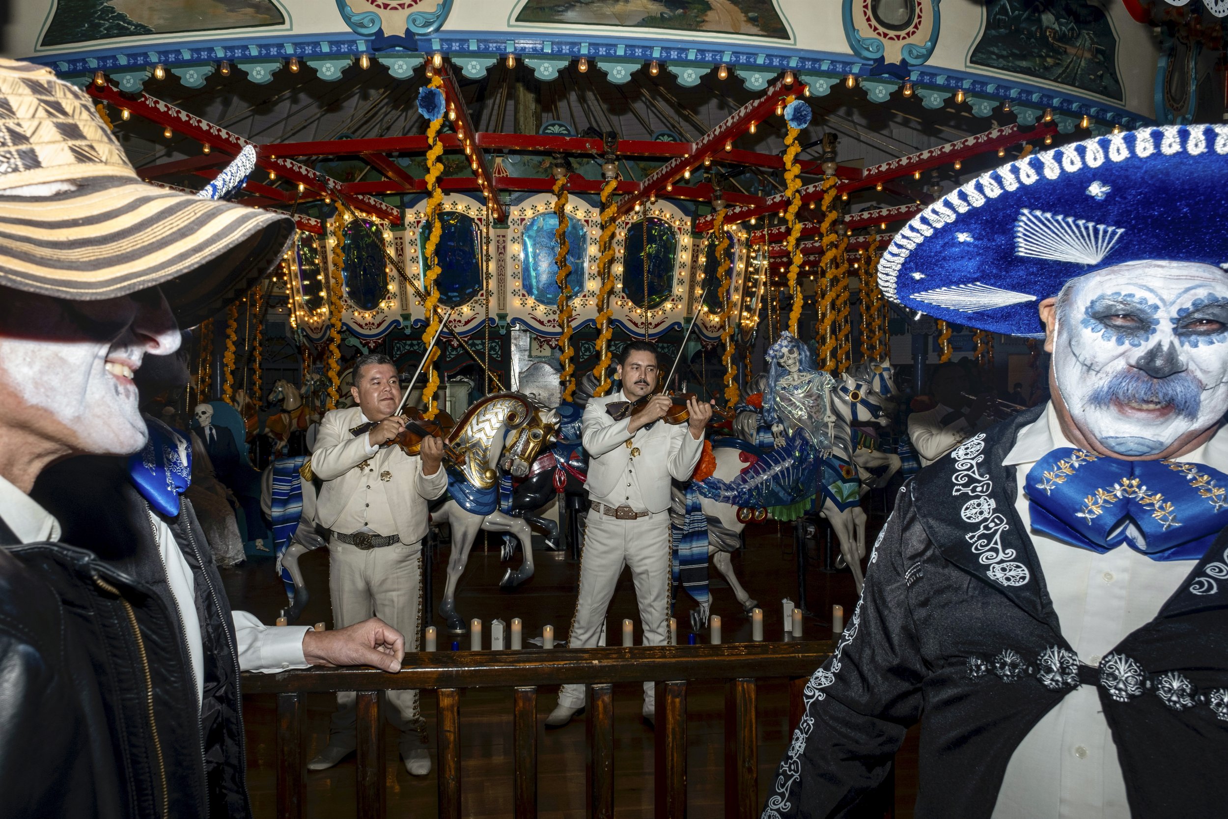  Mariachi Tenamaxtlan de Jalisco performed a variety of songs, as they made their way around the carousel to perform to the crowd of people who gathered to celebrate the Day of the Dead on November 2.  Pablo De La Rosa smiled (right) as Mariachi Tena