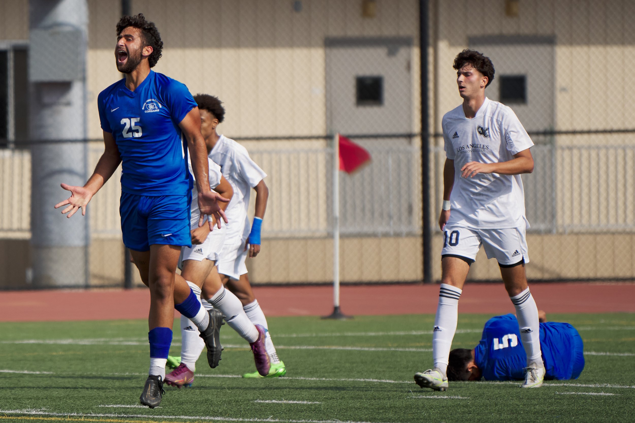  Santa Monica College Corsairs' Adam Abou-Hamad complains after Los Angeles Mission College Eagles' Rivaldo Moreno (not visible), pictured with Yahav Arviv (right), committed an aggressive foul against Jose Urdiano (bottom right) during the men's soc