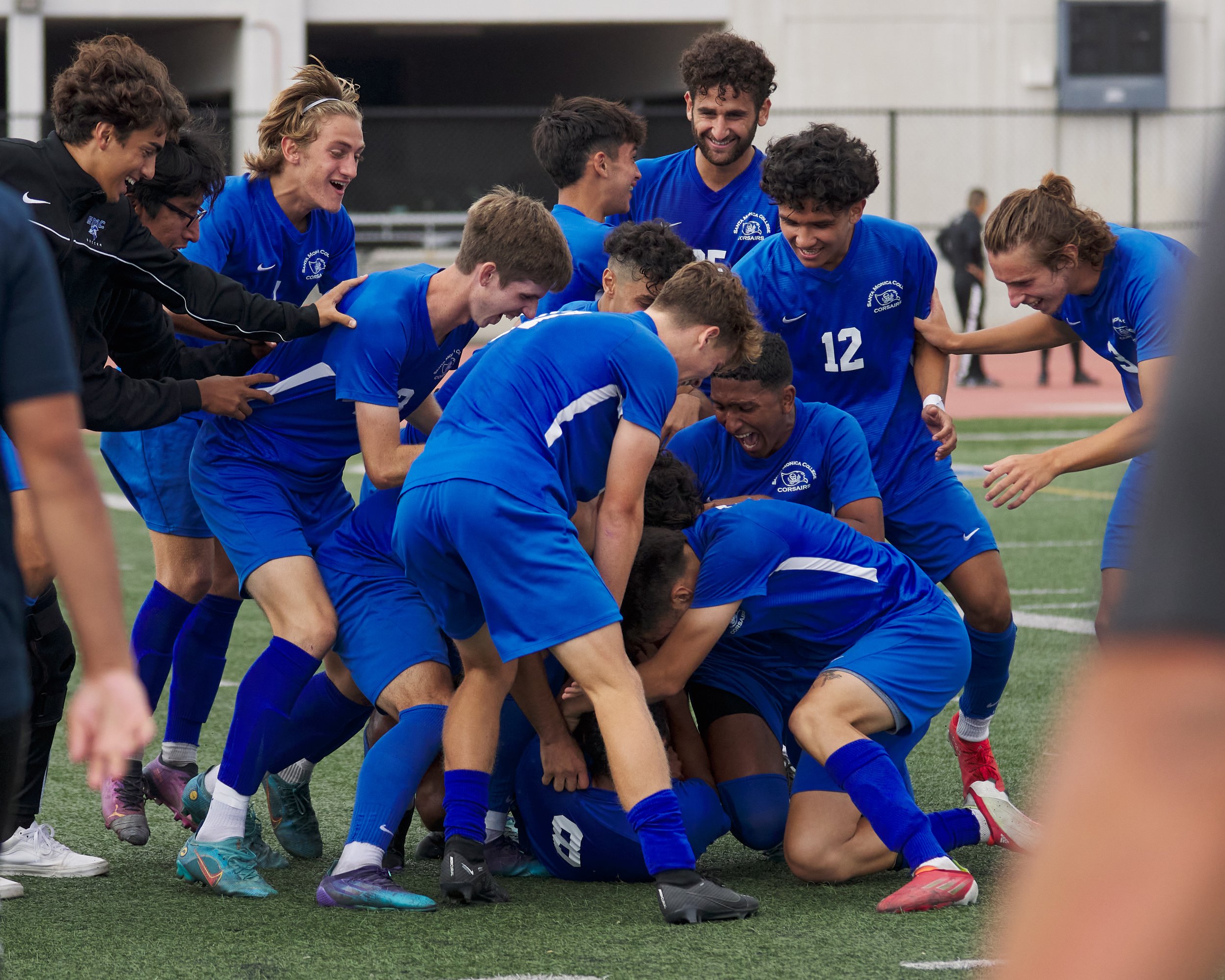  Members of the Santa Monica College Corsairs Men's Soccer team pile on Jaime Toledo (8, bottom) in celebration of his goal during the match against the Los Angeles Mission College Eagles on Tuesday, Nov. 1, 2022, at Corsair Field in Santa Monica, Ca