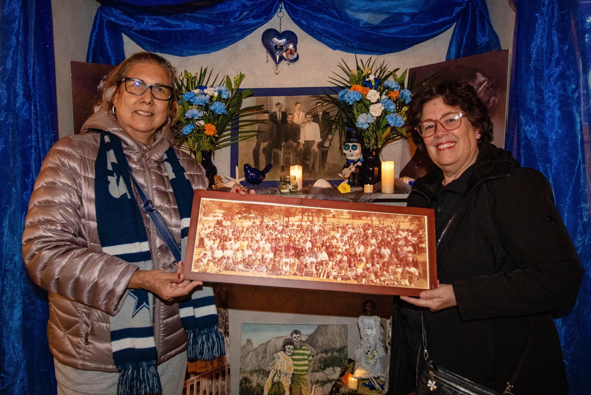  Cousins (L-R) Patricia Casillas and Blanca Casillas Nolan hold up a family photo taken during the year 1980 at one of the altars at the the Santa Monica Pier Día de los Muertos celebration on Nov. 2, 2022. Casillas and Nolan were both in their twent