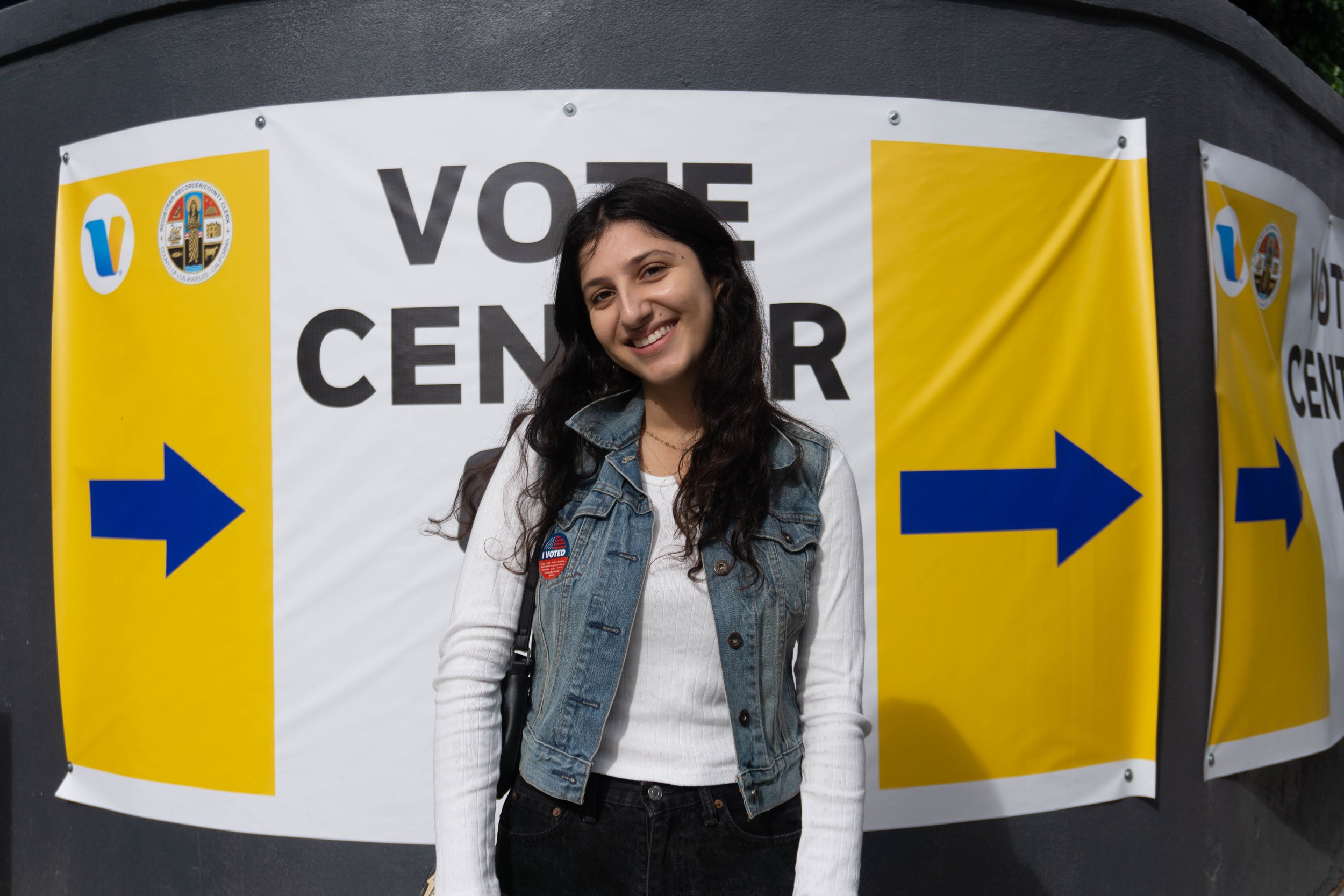  Music major Maya Tons, 19, posing in front of voting signs outside Santa Monica College Cayton Canter faculty lounge after casting her ballot on Tuesday, November 8, 2022, in Santa Monica, Calif. (Daniel De Anda | The Corsair) 