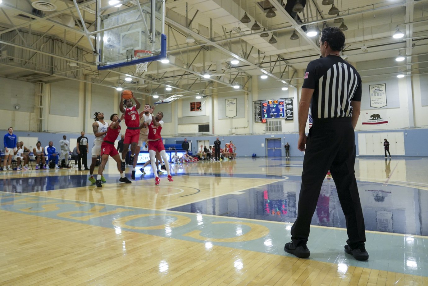  An official looks on as the San Diego City College Knights attempt to score against the Santa Monica college Corsairs during a basketball game at Santa Monica College Saturday, Nov 6 2022. The Corsairs lost the game by a difference of eleven points.