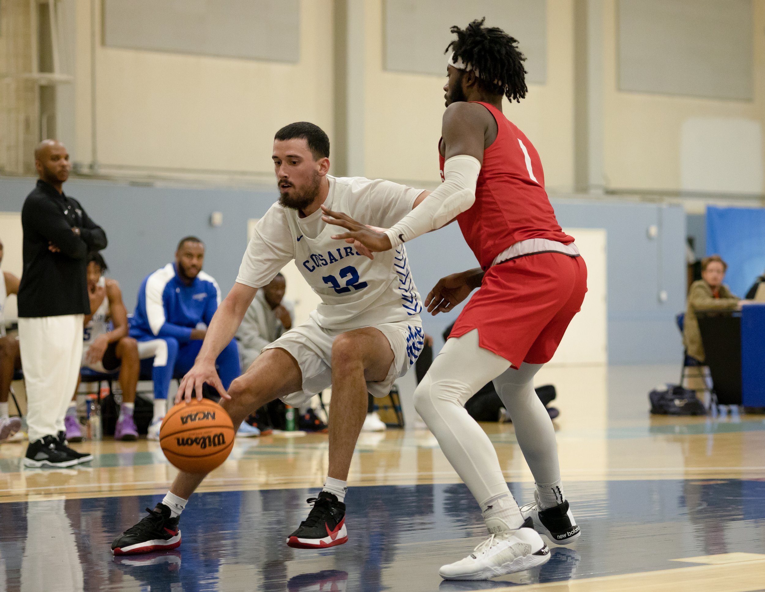  Corsairs center Quinn Collins (left) dribbling the ball while attempting to get around Knights forward Anthony Howell (right) so he can make the shot. November 5, 2022, Santa Monica, Calif. (Jamie Addison | The Corsair) 
