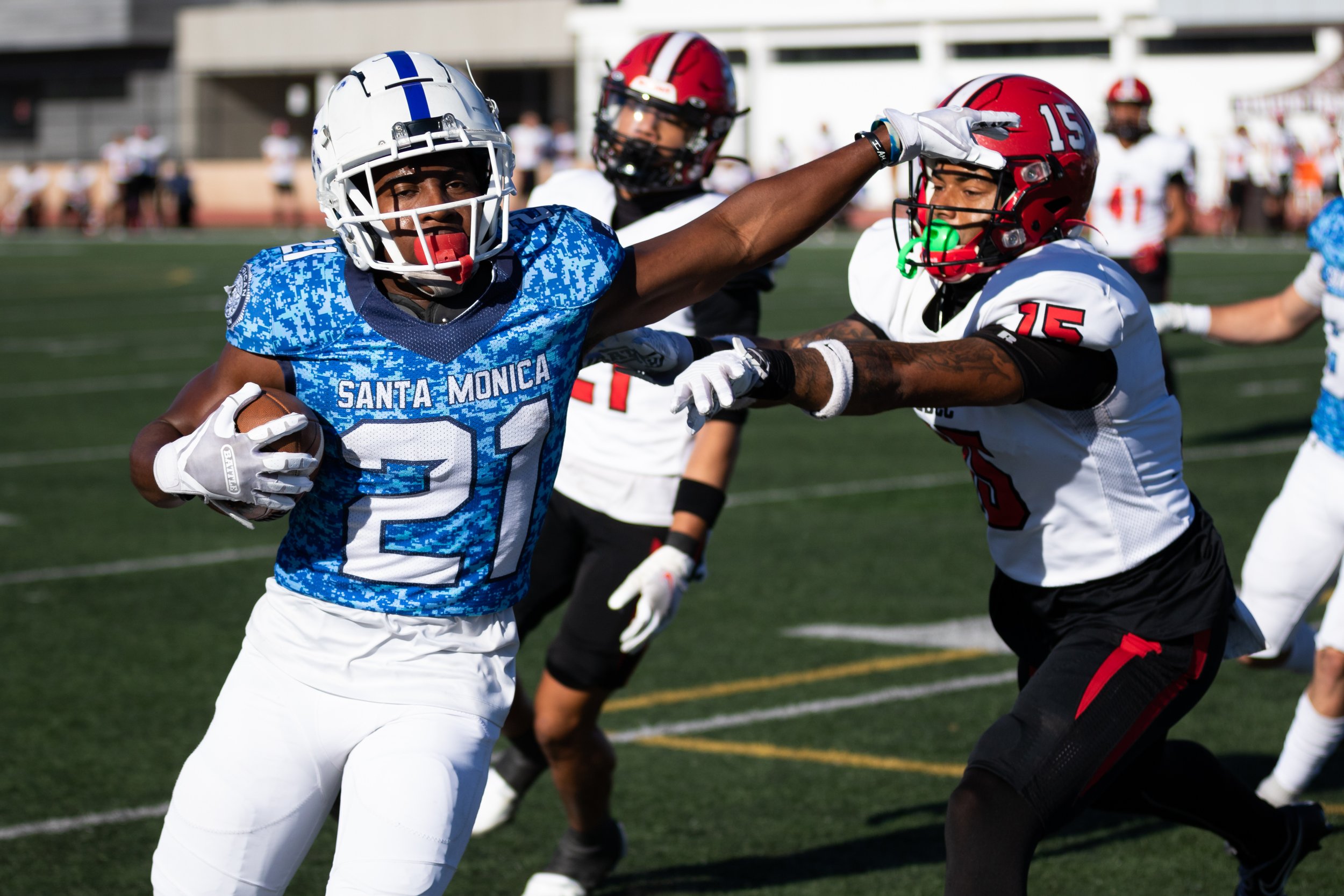  Santa Monica College Corsair Myles Parker (21, left) running the ball as Santa Barbara City College Vaquero Lamar Campbell (15, right) pushes him out of bounds during the second quarter of a recent home game on Saturday, Nov. 12, 2022, at Santa Moni