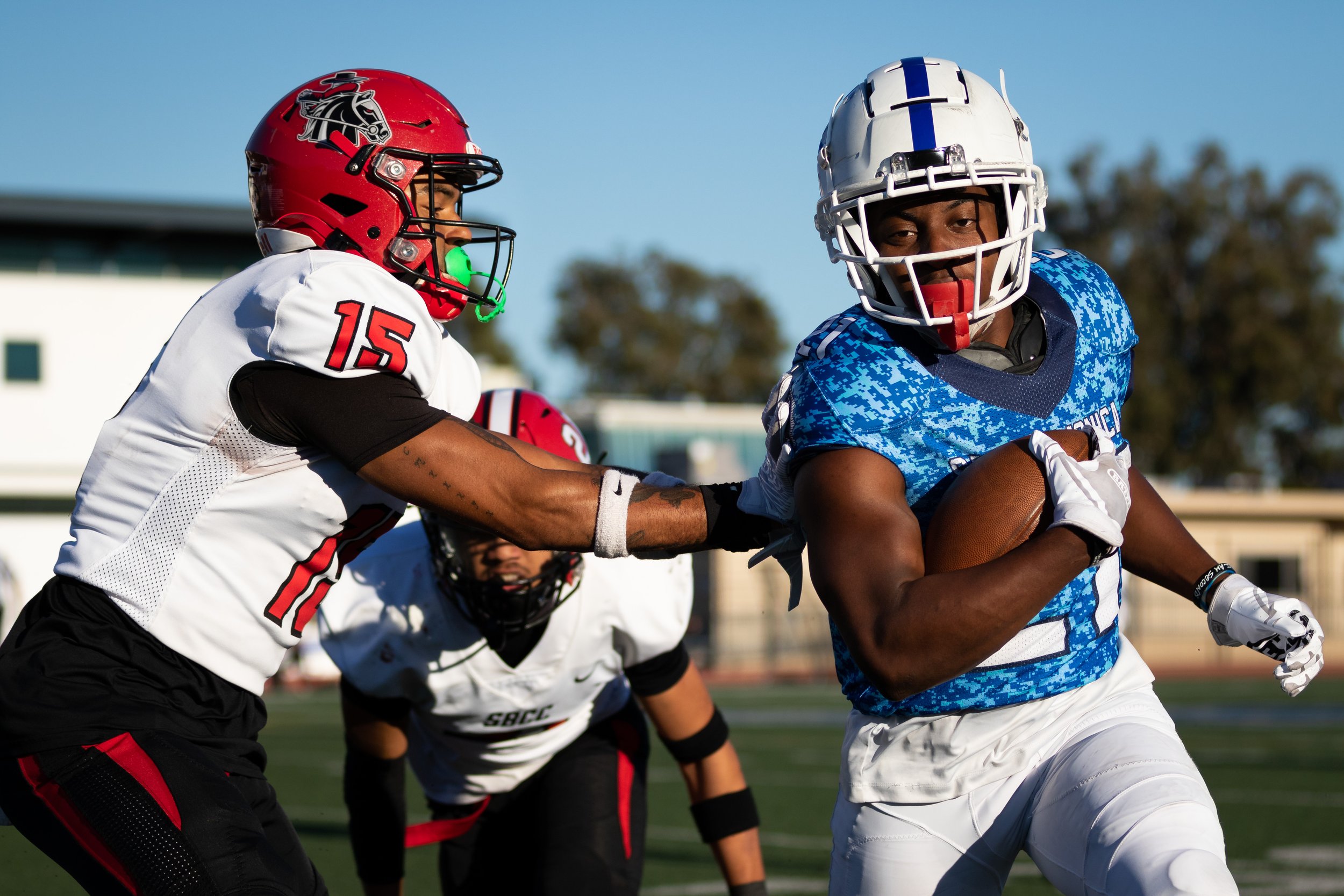  Santa Monica College Corsair Myles Parker (21, right) running the ball as Santa Barbara City College Vaquero Lamar Campbell (15, left) pushes him out of bounds during the third quarter of a recent home game on Saturday, Nov. 12, 2022, at Santa Monic