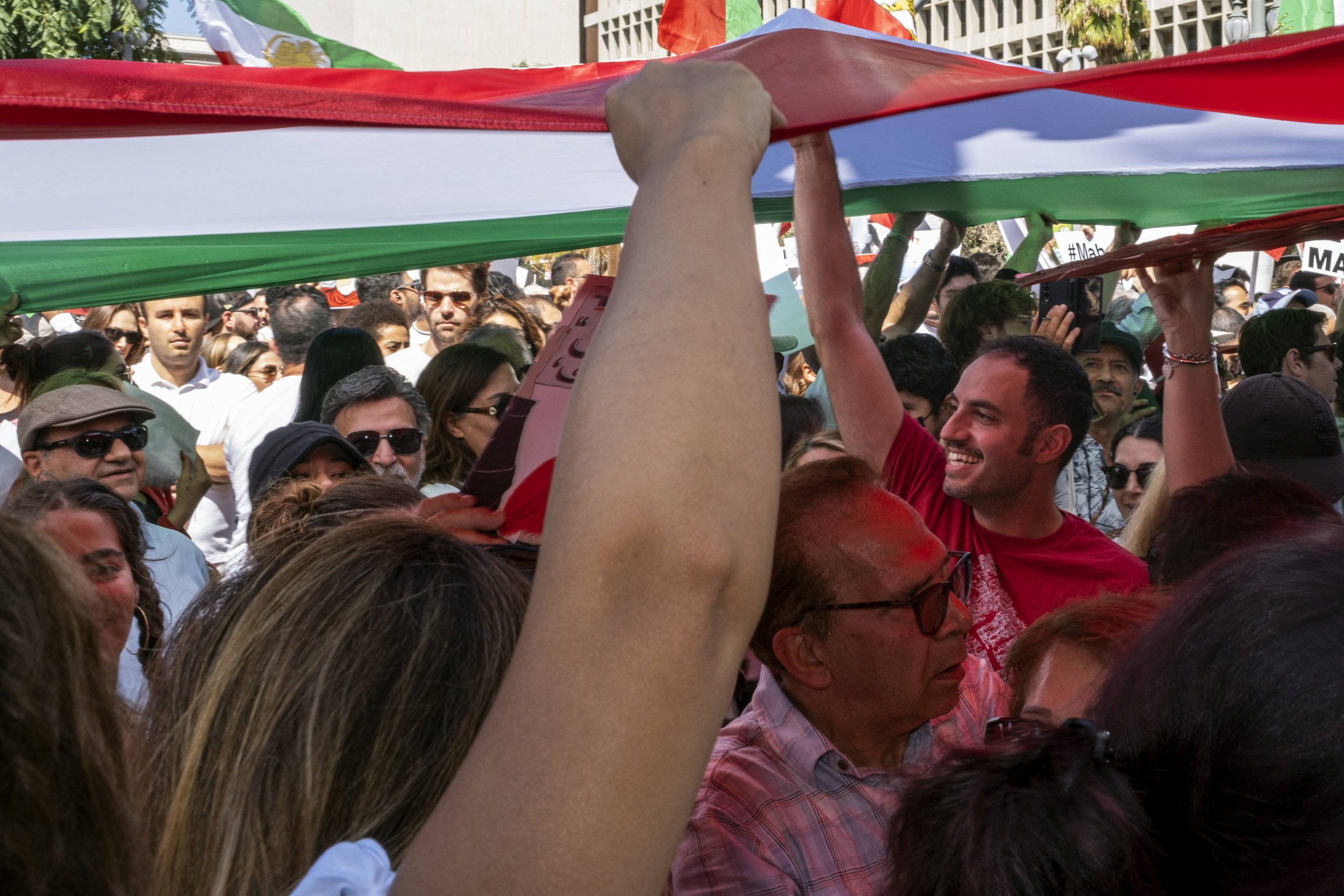  Supporters hold up a large Iranian flag at the Freedom Rally for Iran, in front of Los Angeles City Hall.  (Anna Sophia Moltke | The Corsair) 