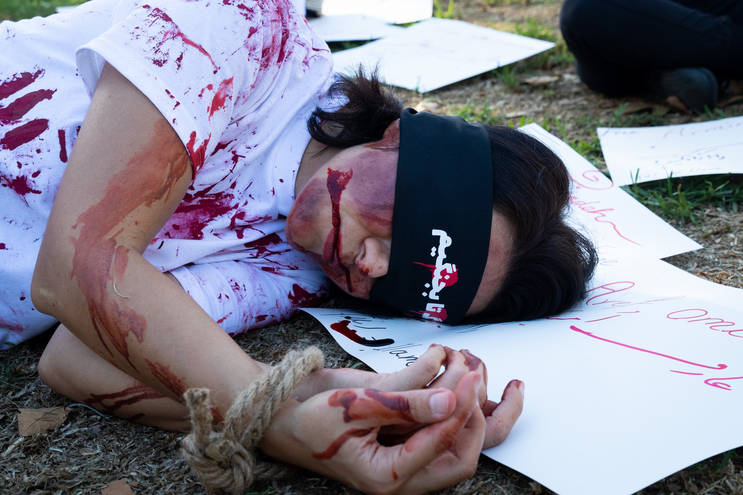 Nikki Vaez performing a die-in in honor of those murdered and imprisoned in Iran. This performance was during the Freedom for Iran human chain in Glendale, Calif., on Saturday, Oct. 29, 2022, as part of a global action. (Caylo Seals | The Corsair) 