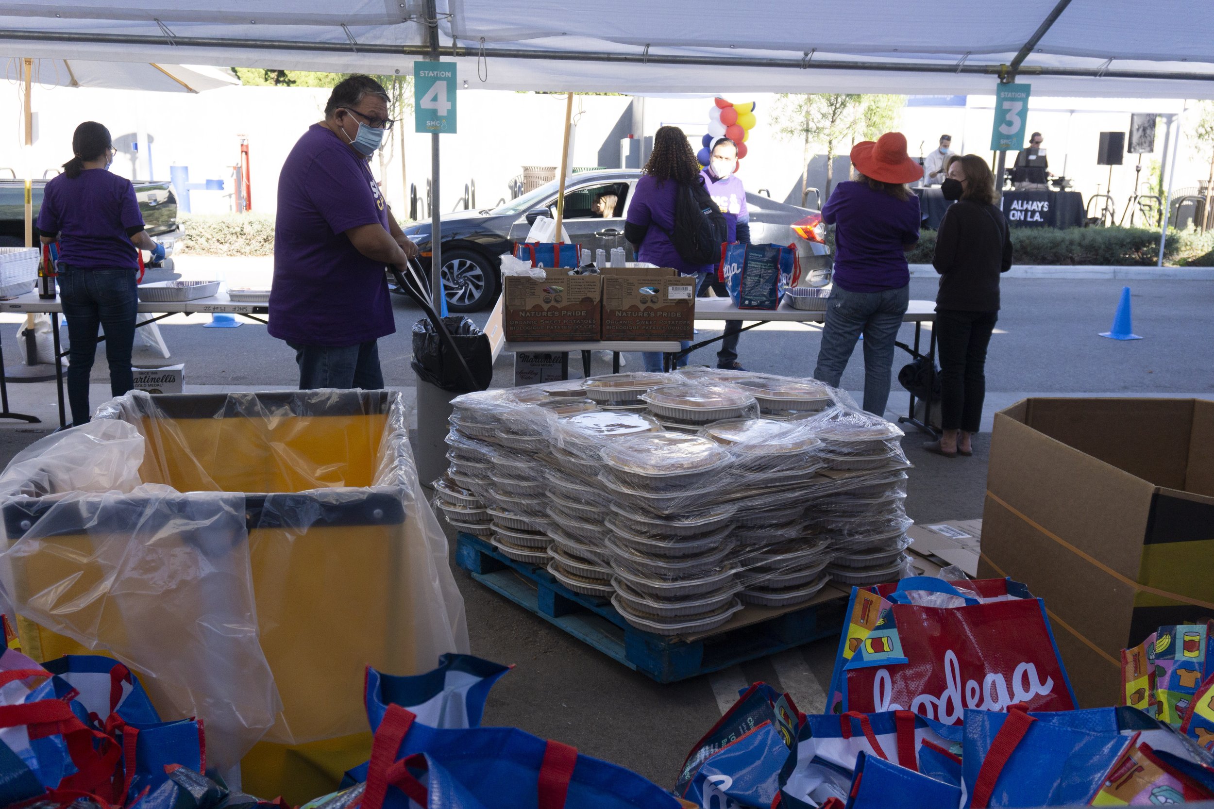  Volunteers restock pumpkin pies at the "Giving Thanks(giving)" drive through foods distribution at Santa Monica College(SMC) on Tuesday, November 22, 2022, in Santa Monica, Calif. The Bodega program combats food insecurities by providing a Thanksgiv