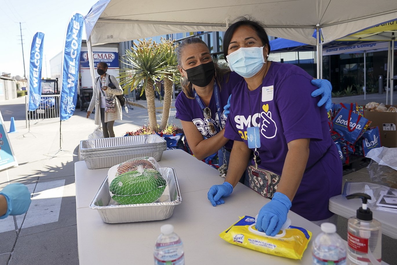  Volunteers pose for a photo during Santa Monica College's 3rd Giving Thanks(Giving) charity food distribution event Tuesday, Nov. 22 2022. The drive-thru market featured free care packages designed to ease the burden faced by food-insecure students.