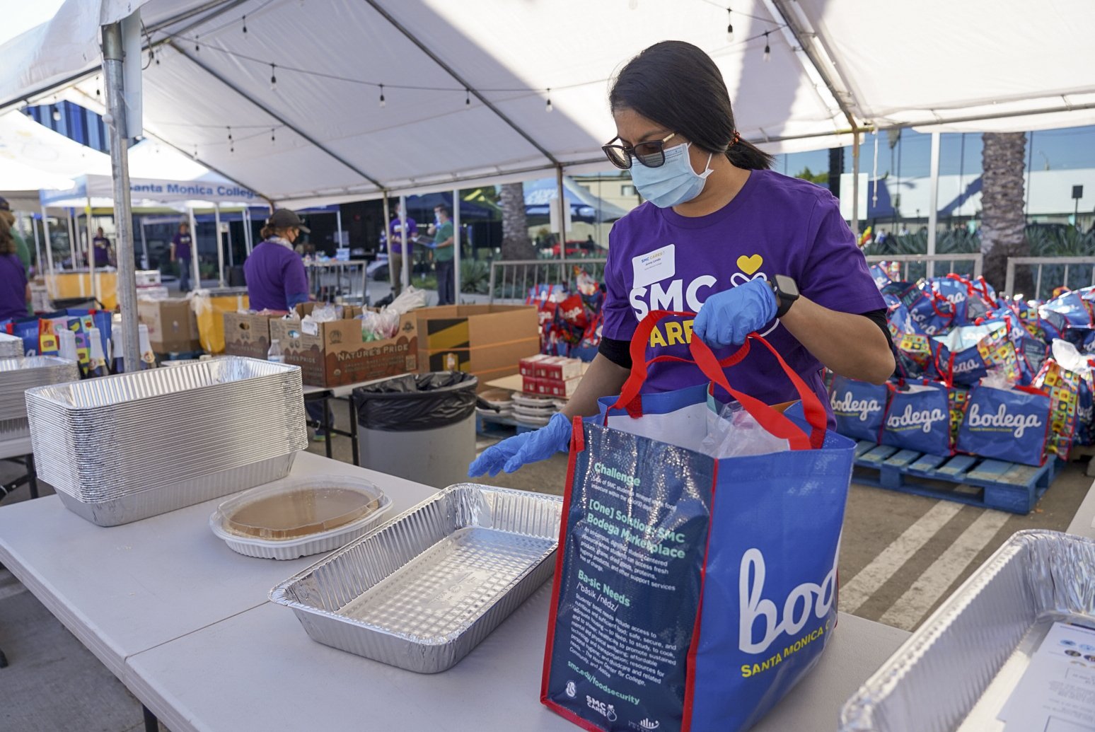  Jenny Landa, Santa Monica College Cares volunteer, constructs a care package for student recipients during Santa Monica College's 3rd Giving Thanks(Giving) charity food distribution event Tuesday, Nov. 22 2022. The drive-thru market featured free it