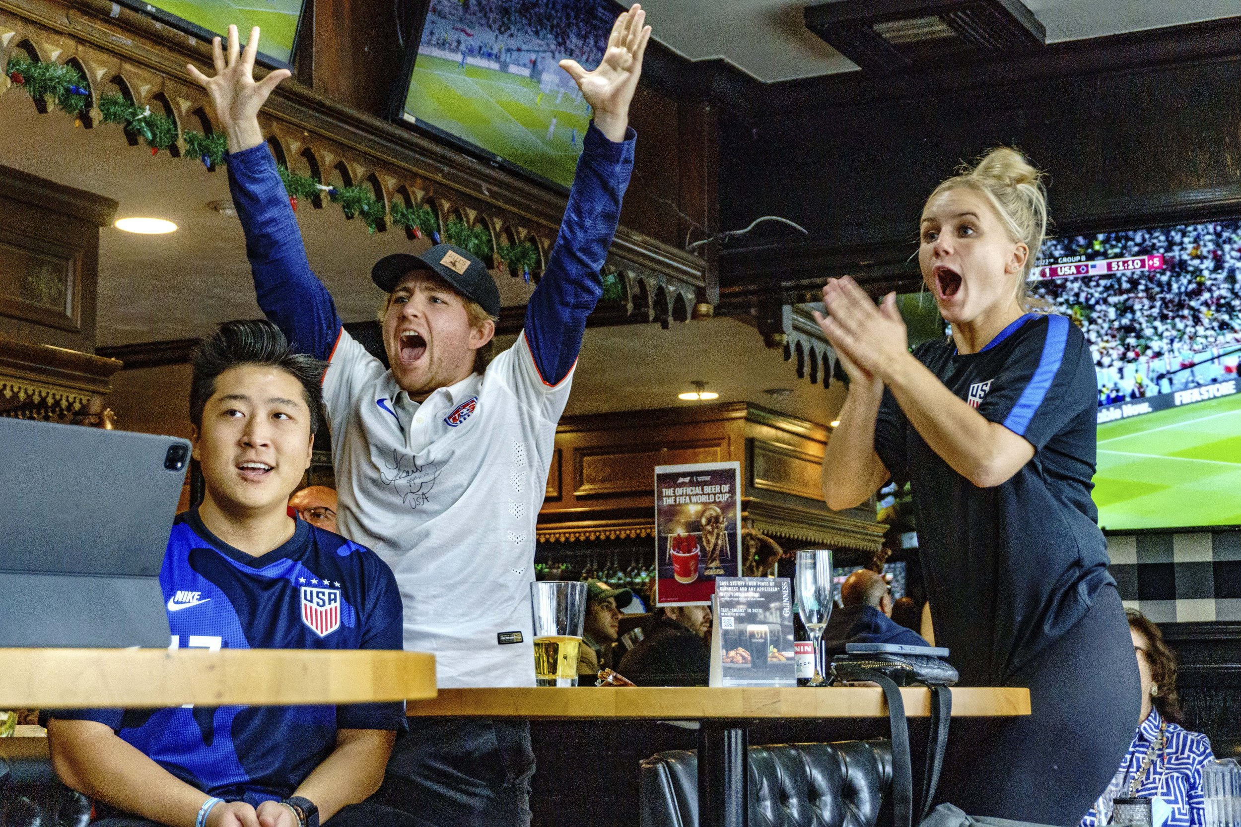  Friends Will Pai, Matt Fanelli and Bridget Toll cheer and support the USA soccer team as they play against Iran in the FIFA World Cup Qatar 2022 at Busby's West sports bar and restaurant in Santa Monica. The US team beat Iran 1-0 and are through to 