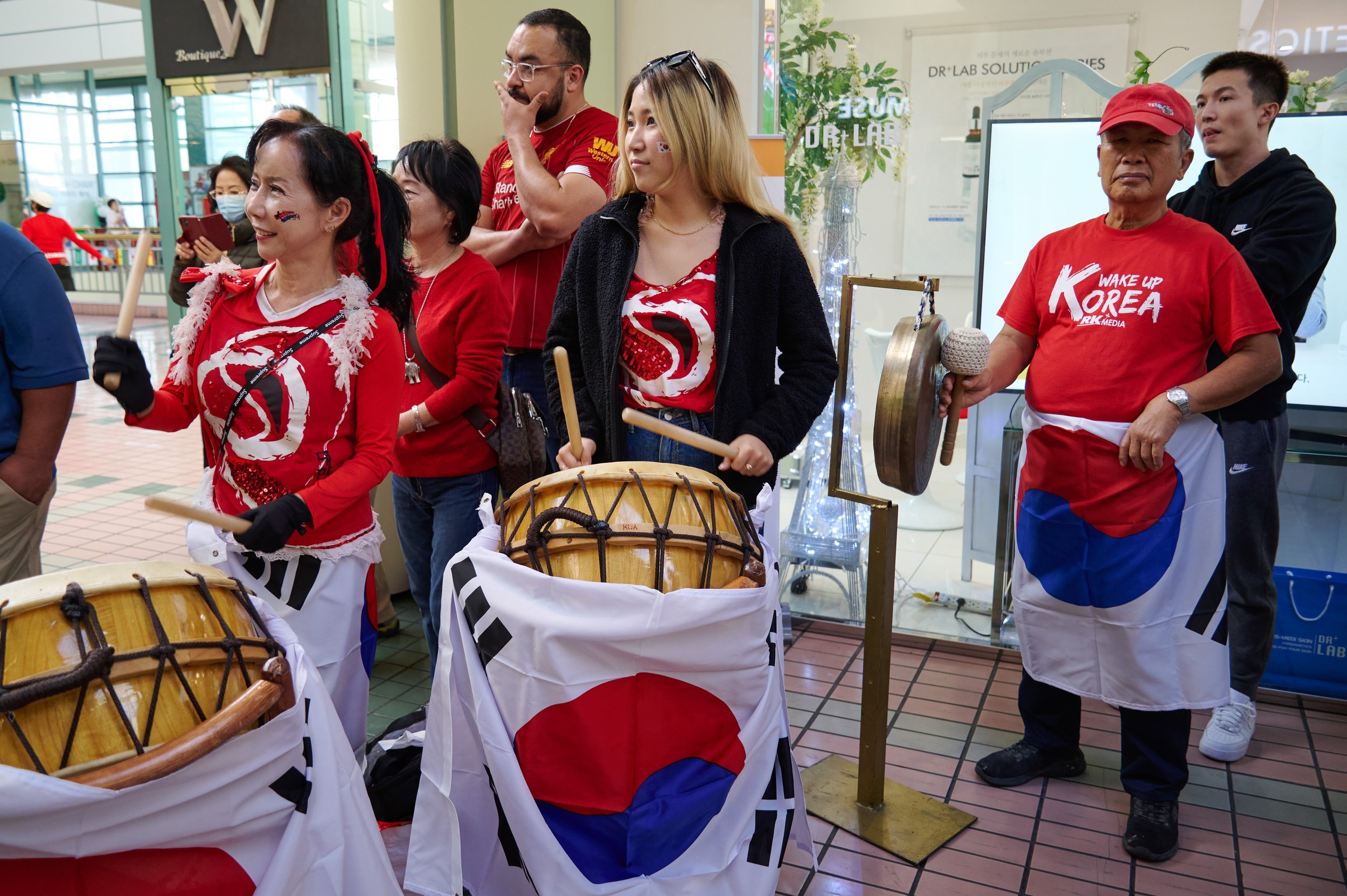  Jean Choi, Irene Choi, and Danny Shon, from Jean Ballet School, play drums and gong during the Koreatown Community World Cup Viewing Party at Koreatown Plaza on Monday, Dec. 5, 2022, in Los Angeles, Calif. (Nicholas McCall | The Corsair) 