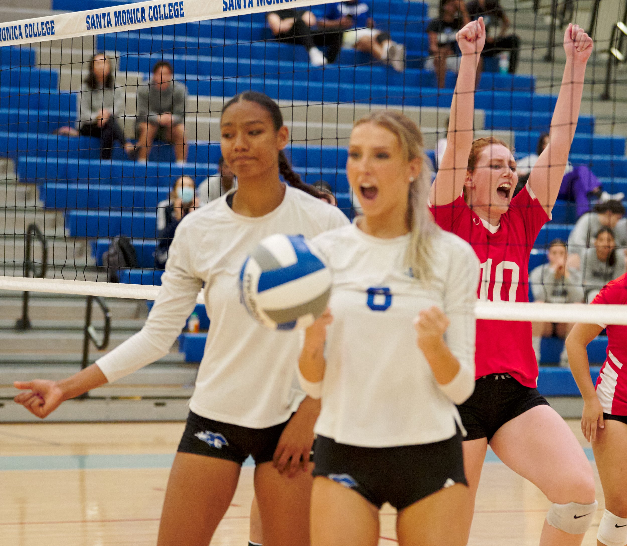  College of the Desert Roadrunners' Katie Alexander (right) celebrates the team's scoring after getting past the blocking by Santa Monica College Corsairs' Rain Martinez (left) and Sophia Lawrance (center) during the women's volleyball match on Frida