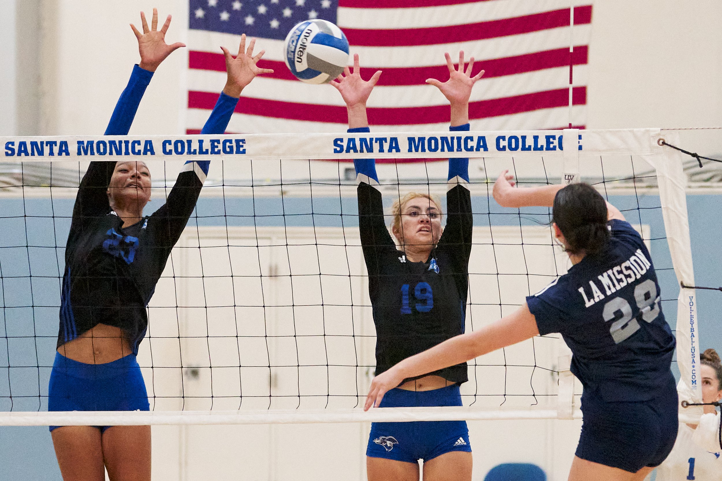  Los Angeles Mission College Eagles' Jaylah Moreno hits the ball past Santa Monica College Corsairs' defense by Rain Martinez and Scheala Nielsen during the women's volleyball match on Friday, October 7, 2022, at the Corsair Gym in Santa Monica, Cali