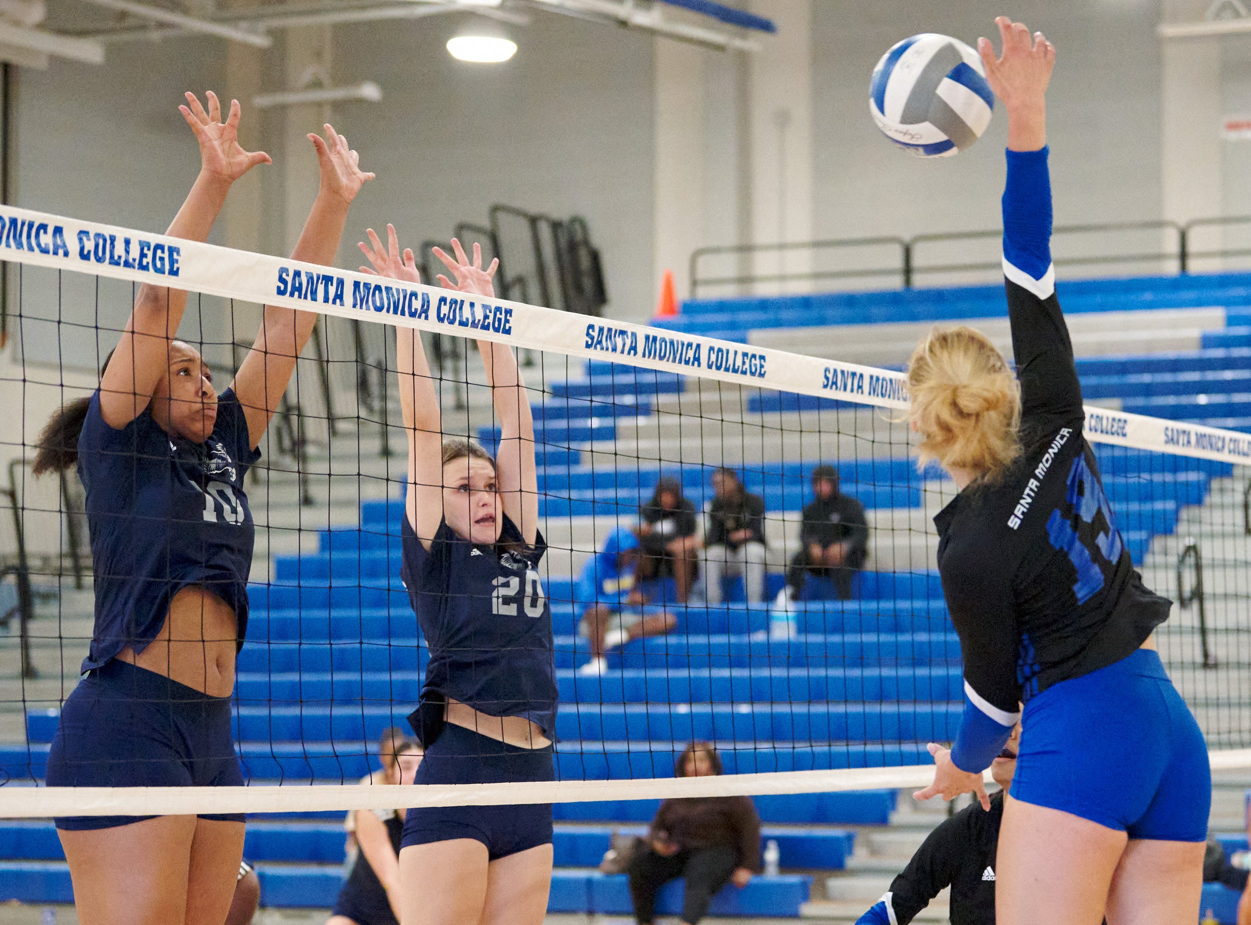  Santa Monica College Corsairs' Scheala Nielsen (right) hits the ball past Los Angeles Mission College Eagles' defense by Jaya Davison (left) and McKenna Keil (right) during the women's volleyball match on Friday, October 7, 2022, at the Corsair Gym 