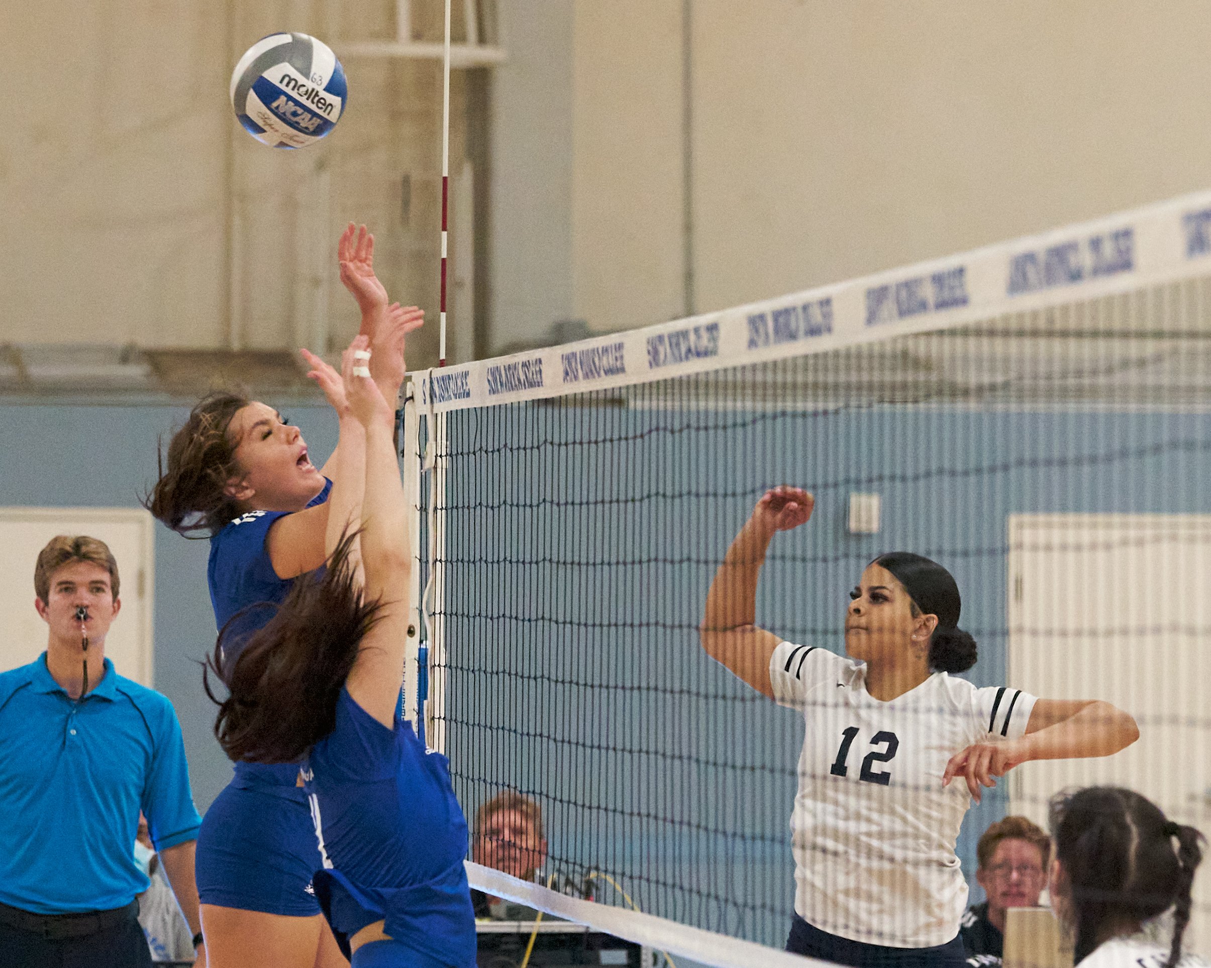  College of the Canyons Cougars' Kaelyn White (right) hits the ball past Santa Monica College Corsairs' Mackenzie Wolff (left) and Maiella Riva during the women's volleyball match on Friday, Oct. 28, 2022, at SMC Gym in Santa Monica, Calif. The Corsa