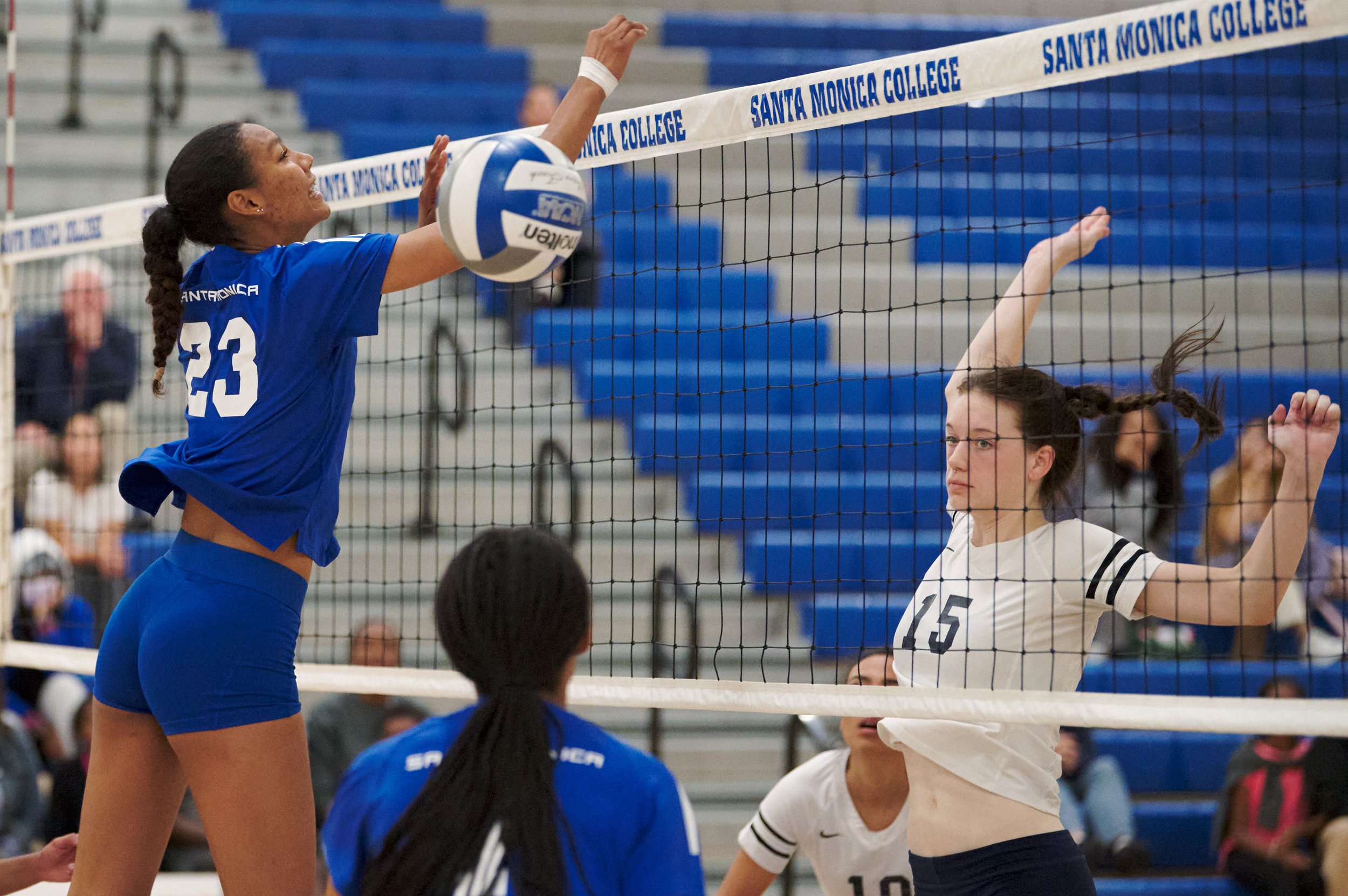  College of the Canyons Cougars' Aly Grodell (right) hits the ball past Santa Monica College Corsairs' Rain Martinez (left) during the women's volleyball match on Friday, Oct. 28, 2022, at SMC Gym in Santa Monica, Calif. The Corsairs lost 1-3. (Nicho