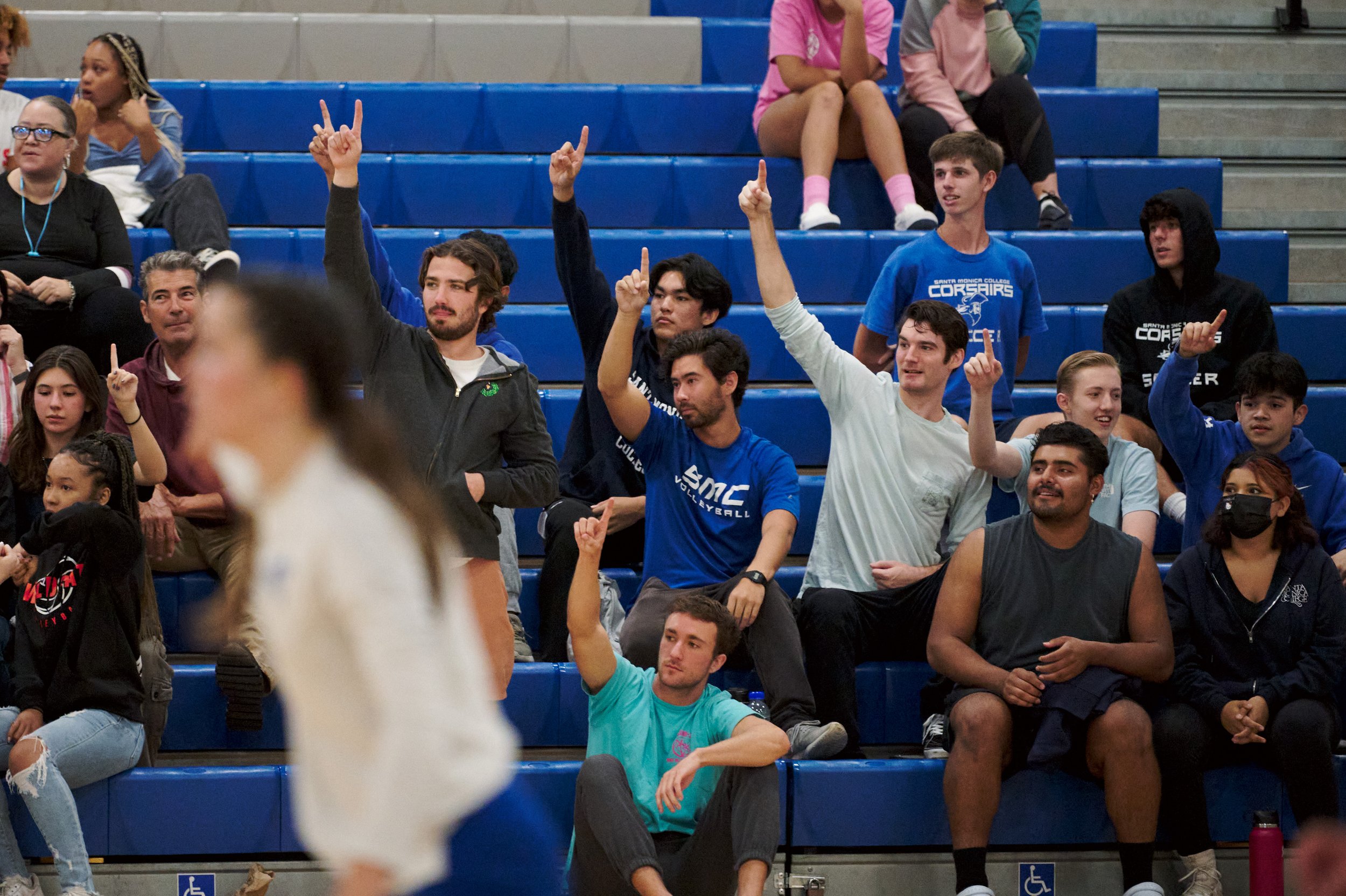  Members of the Santa Monica College Corsairs Men's Volleyball team hold up one finger in support of the women's team needing one more point to win the game against the West Los Angeles College Wildcats on Wednesday, Oct. 26, 2022, at SMC Gym in Sant