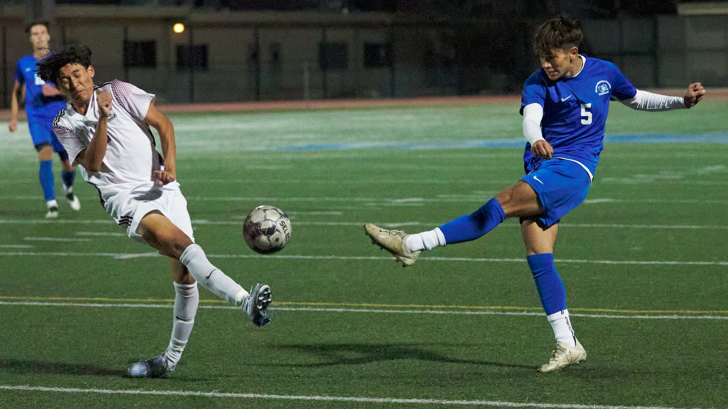  Santa Monica College Corsairs' Jose Urdiano (right) kicks the ball past Norco College Mustangs' Andrew Montes (left) during the men's soccer match on Saturday, Nov. 19, 2022, at Corsair Field in Santa Monica, Calif. (Nicholas McCall | The Corsair) 