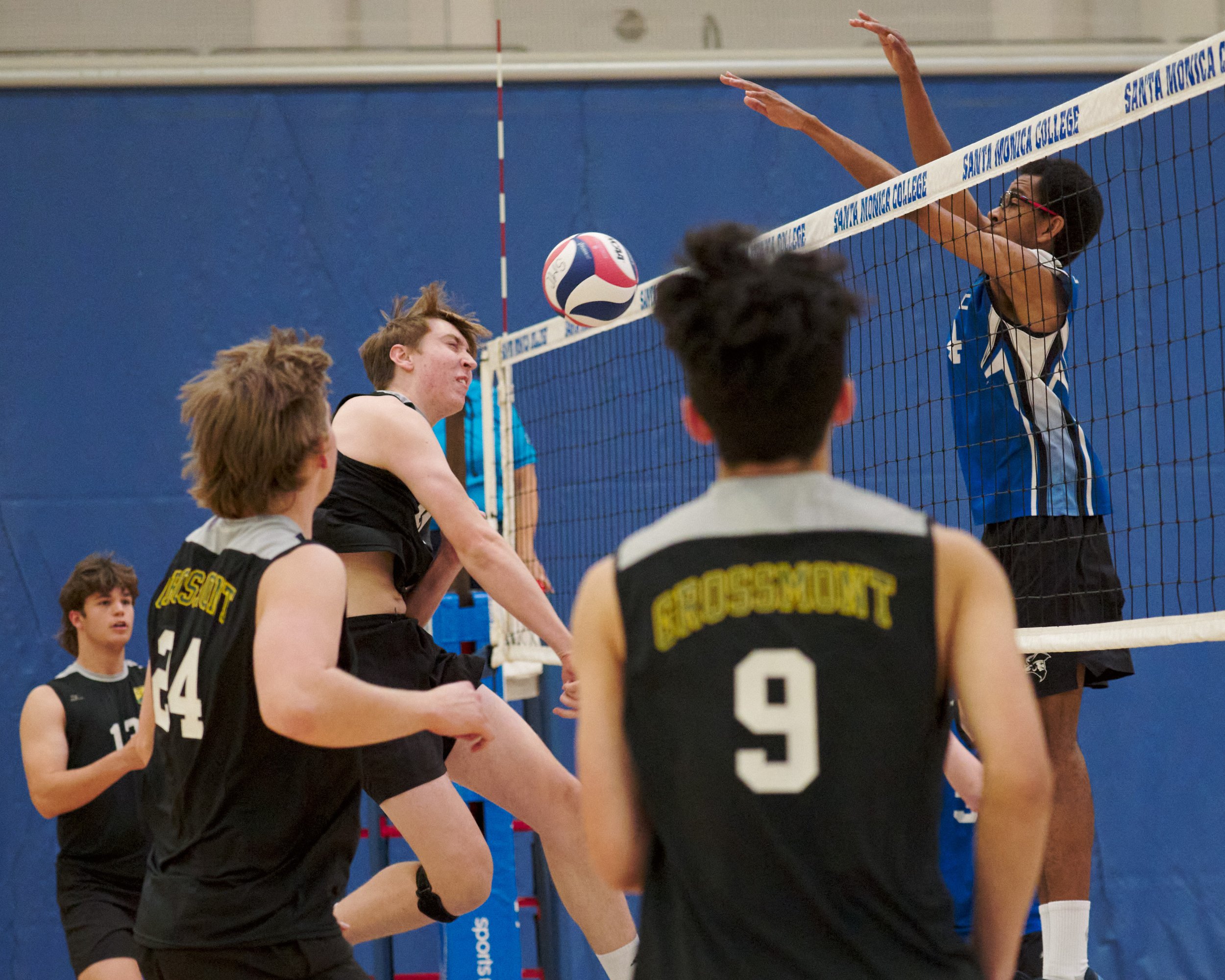  Santa Monica College Corsairs' Beikwaw Yankey (right) blocks the ball sent by Grossmont College Griffins' Tanner May (center) during the men's volleyball match on Wednesday, Feb. 15, 2023,  at Corsair Gym in Santa Monica, Calif. The Corsairs won 3-0
