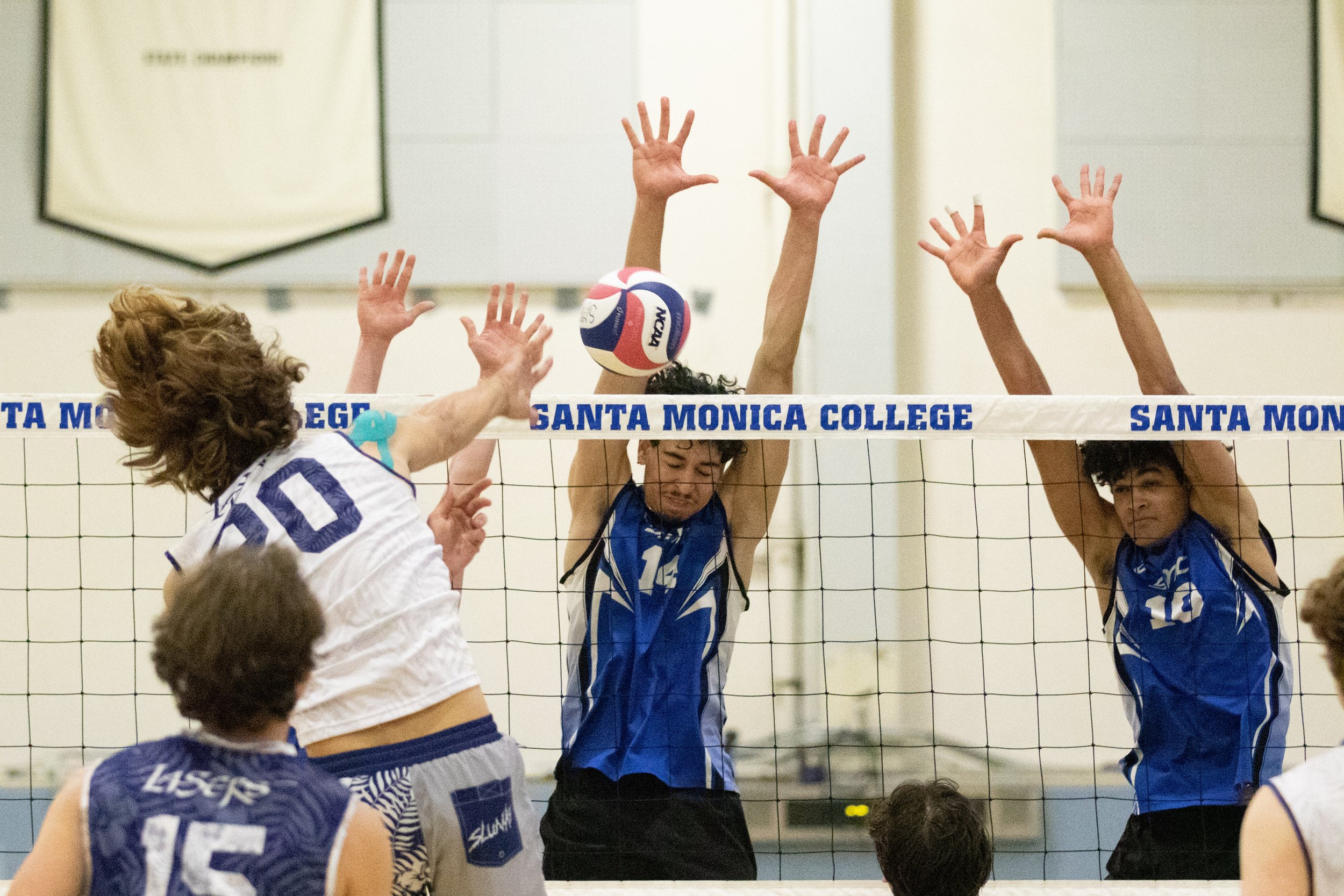  Santa Monica College Corsairs oppisite Luis Garzon (14, center) and outside hitter Nate Davis (10, right) attempt to block a kill by Irvine Valley College Laser outside hitter Andrew McFall (10, left) during the first set of a home game in Santa Mon
