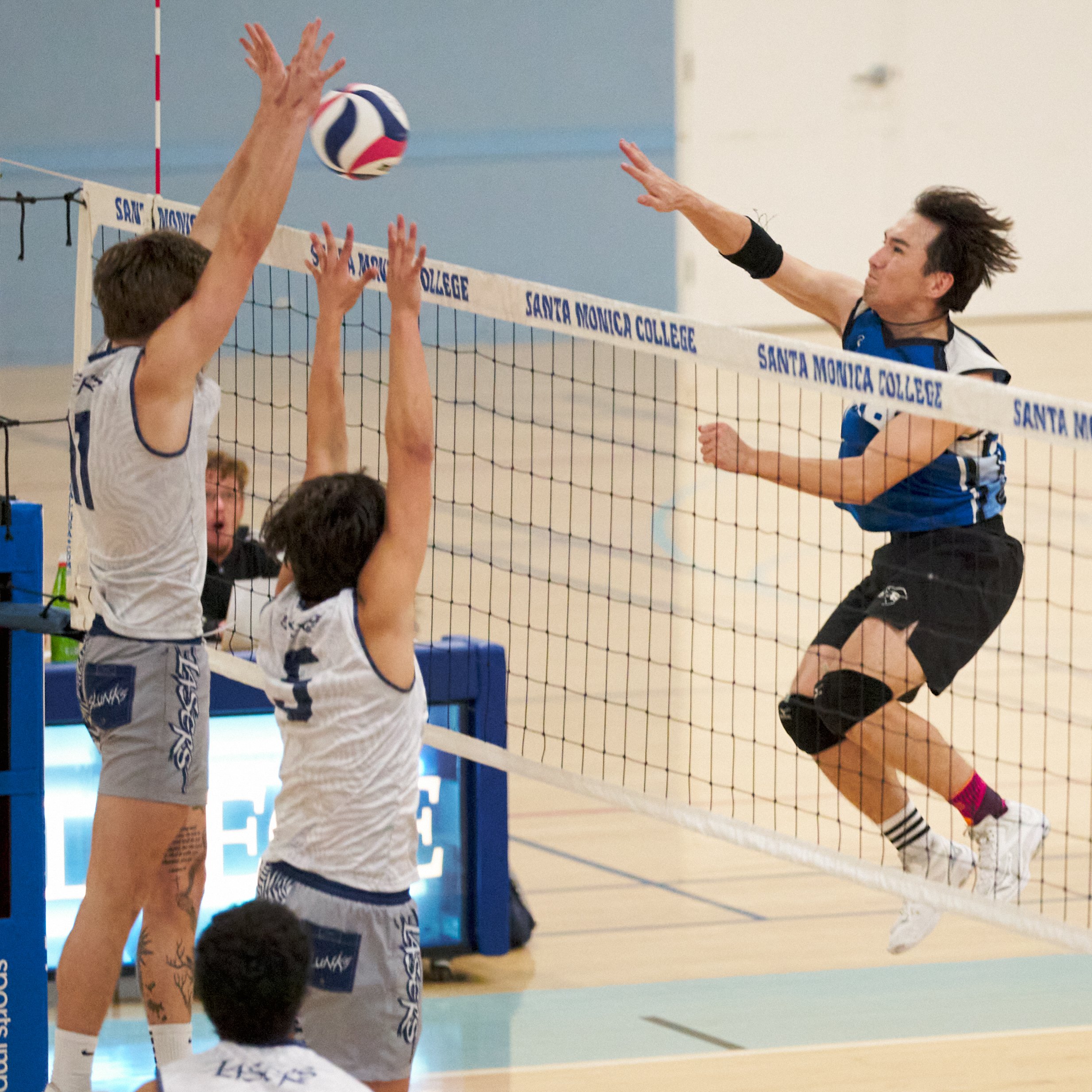  Santa Monica College Corsairs' Enkhtur Tserendavaa (right) sends the ball past Irvine Valley College Lasers' Zach McEntire (left) and Julio Gutierrez (center) during the men's volleyball match on Friday, Feb. 24, 2023, at Corsair Gym in Santa Monica